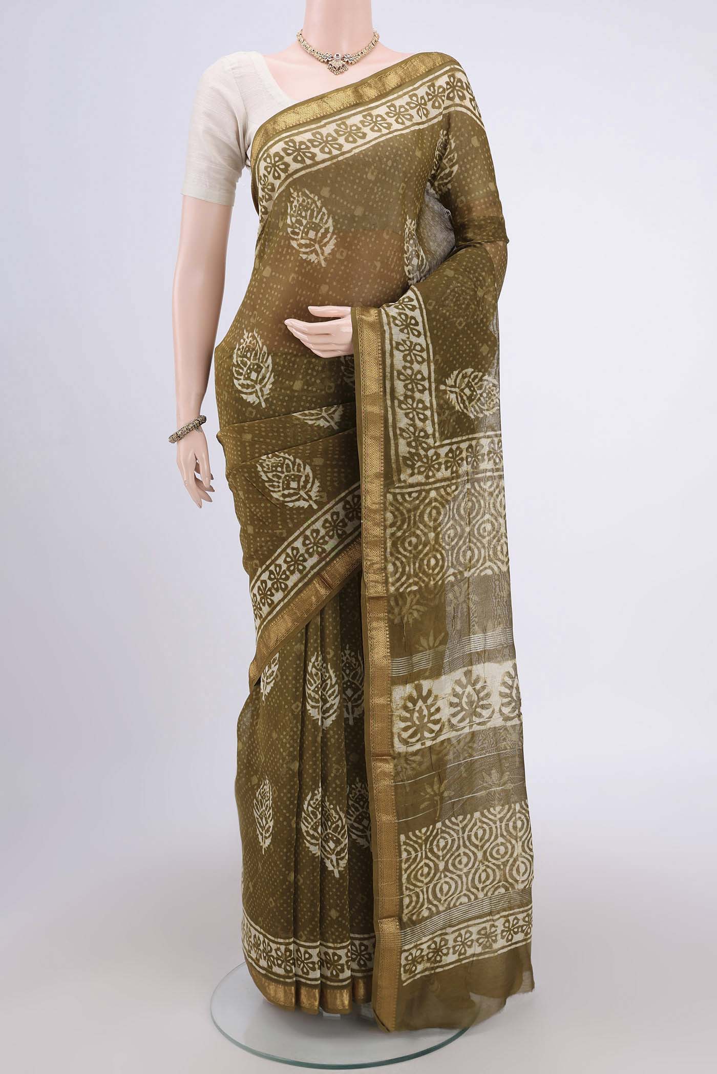Mehandi Green Maheshwari Silk Cotton Saree with Printed design on the body and Zari Border.  displayed on a mannequin