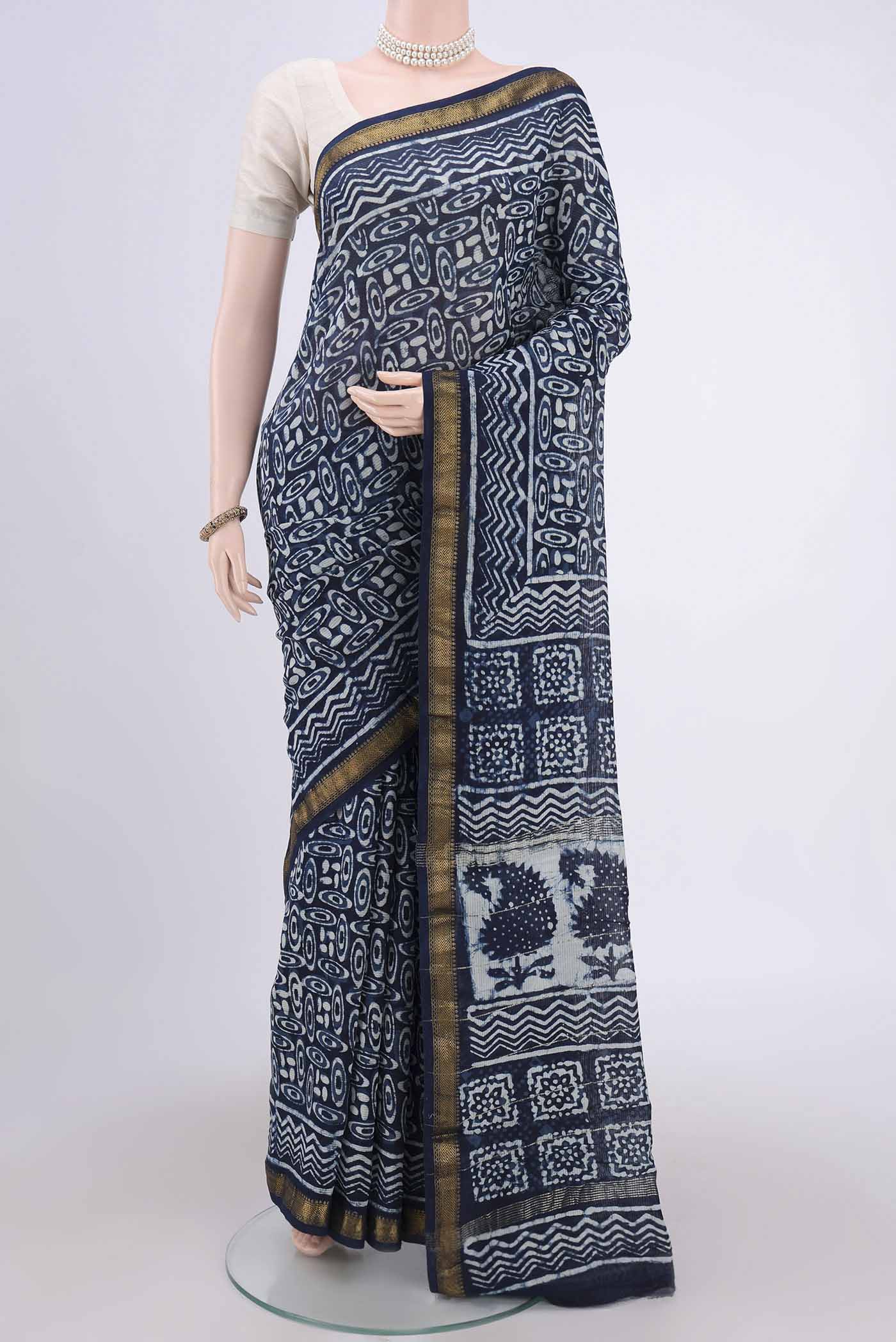 Indigo Maheshwari Silk Cotton Saree with Batik Print on the body and Zari Border.  displayed on a mannequin