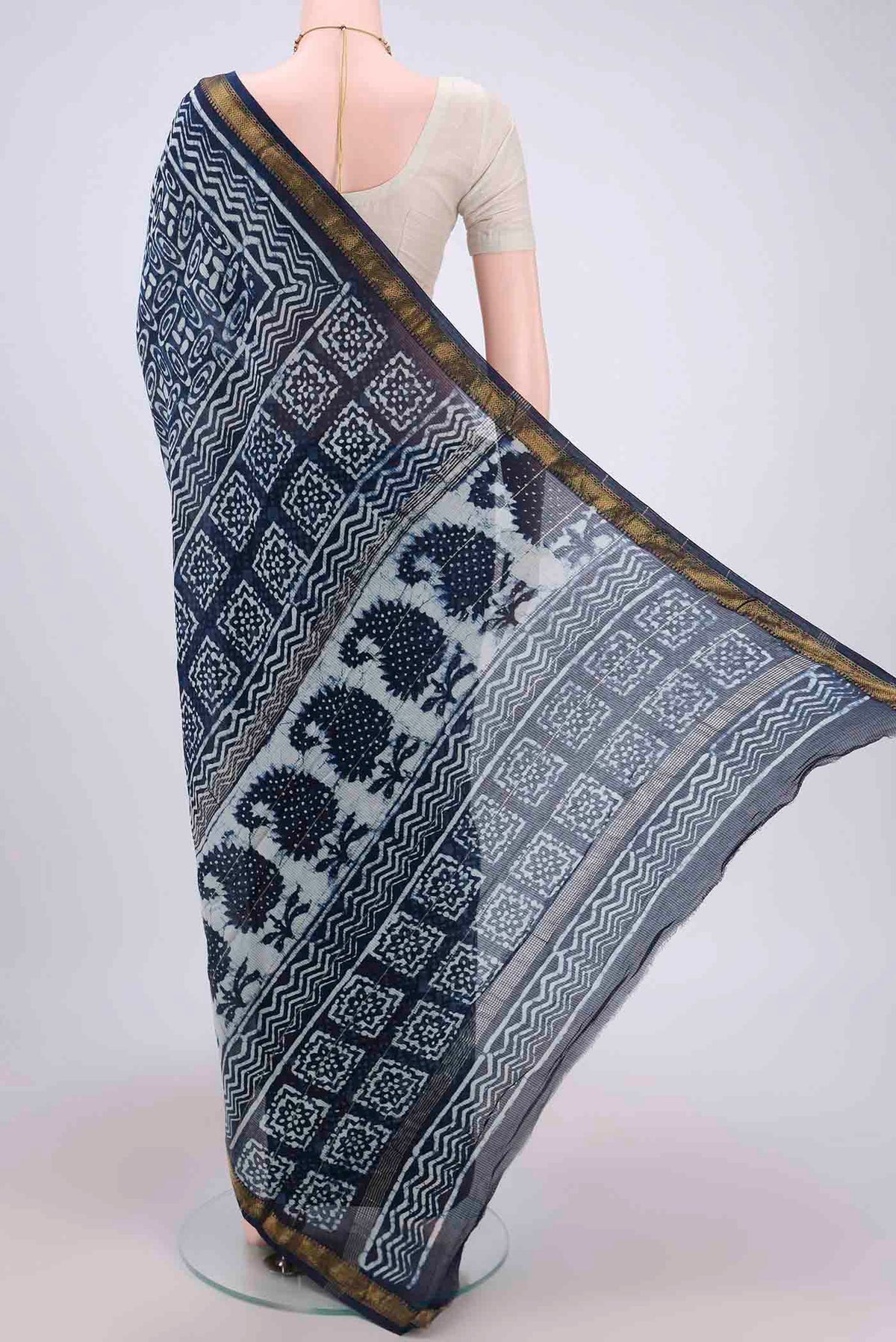 Flat view of Indigo Maheshwari Silk Cotton Saree with Batik Print on the body and Zari Border. 