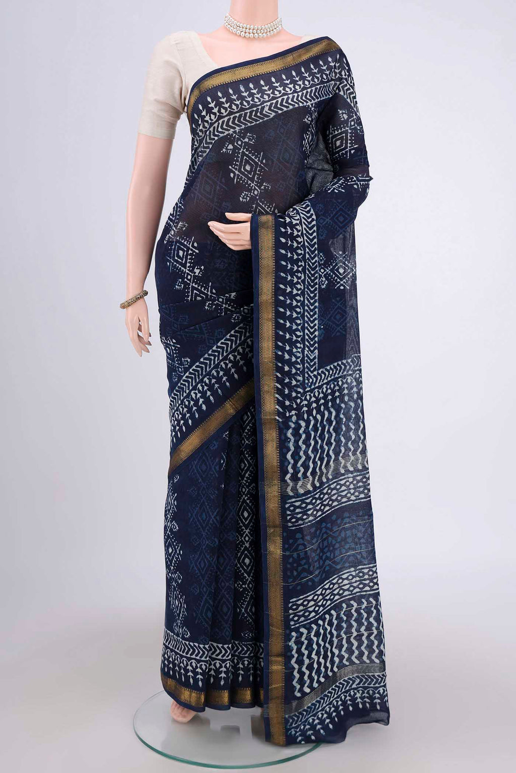 Indigo Maheshwari Silk Cotton Saree with Batik Print on the body and Zari Border.  displayed on a mannequin