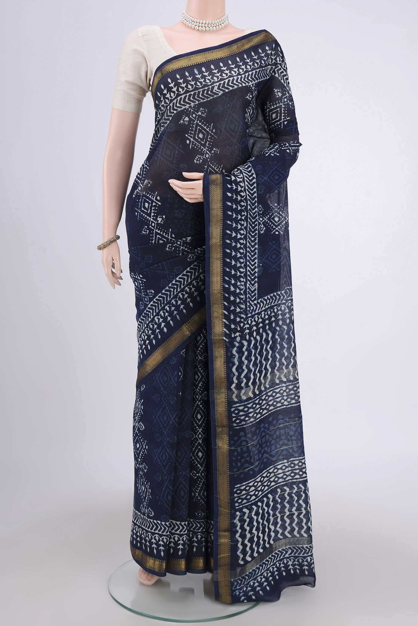 Indigo Maheshwari Silk Cotton Saree with Batik Print on the body and Zari Border.  displayed on a mannequin