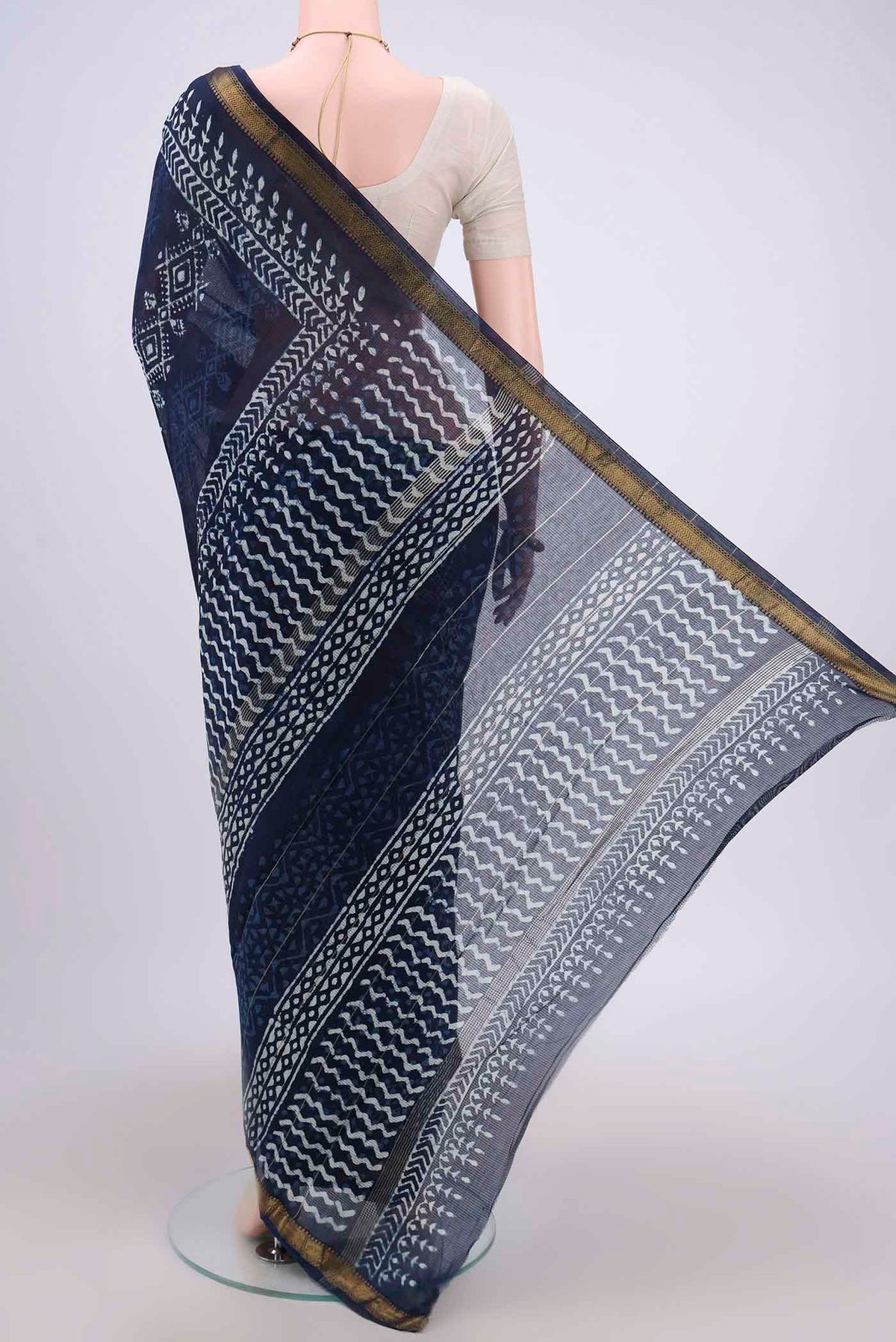 Flat view of Indigo Maheshwari Silk Cotton Saree with Batik Print on the body and Zari Border. 