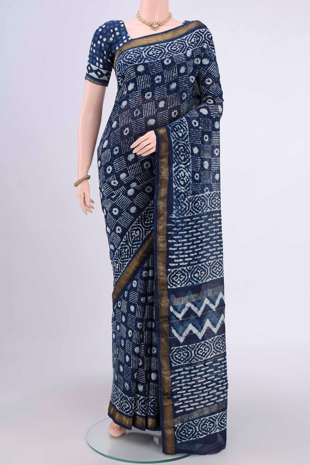 Indigo Maheshwari Silk Cotton Saree with Printed design on the body and Zari Border.  displayed on a mannequin