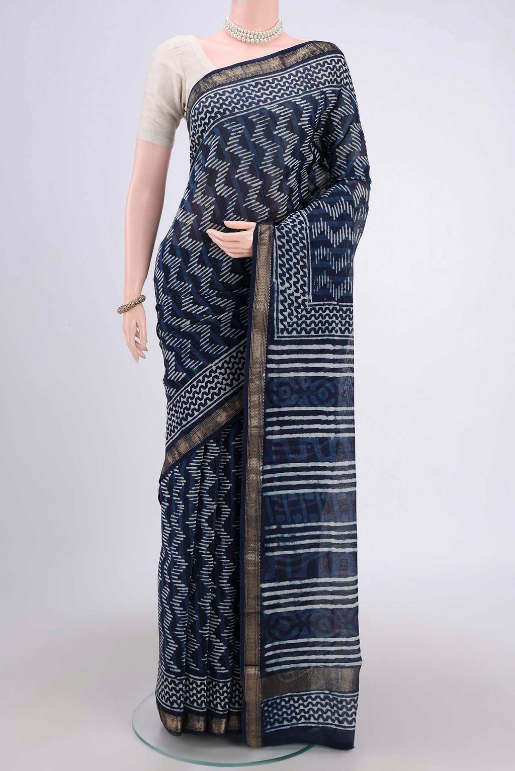 Indigo Maheshwari Silk Cotton Saree with Batik Print on the body and Zari Border.  displayed on a mannequin