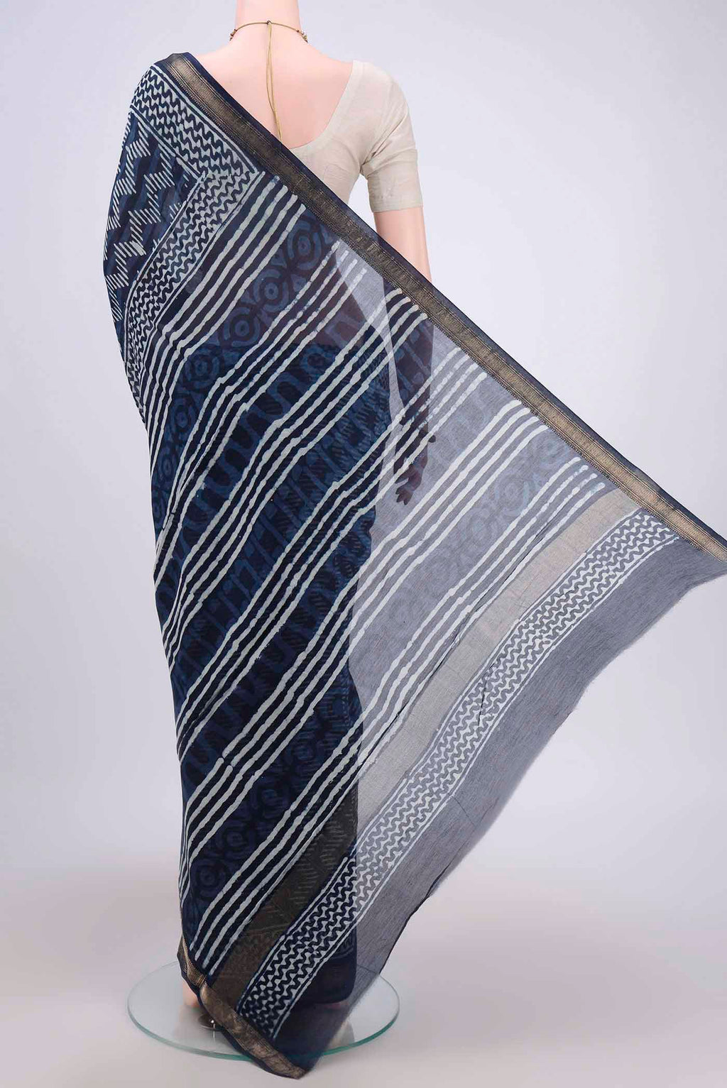 Flat view of Indigo Maheshwari Silk Cotton Saree with Batik Print on the body and Zari Border. 