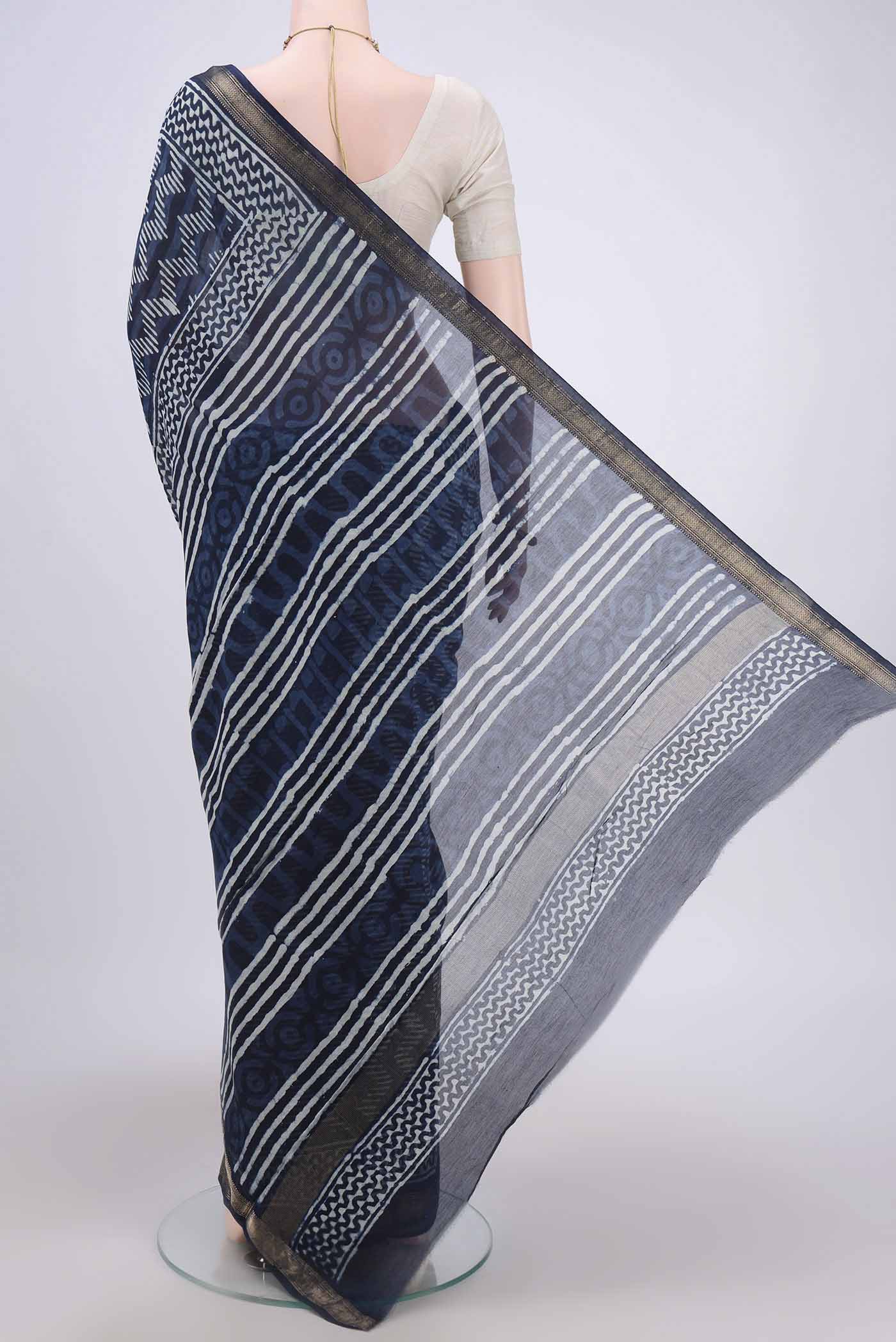 Flat view of Indigo Maheshwari Silk Cotton Saree with Batik Print on the body and Zari Border. 