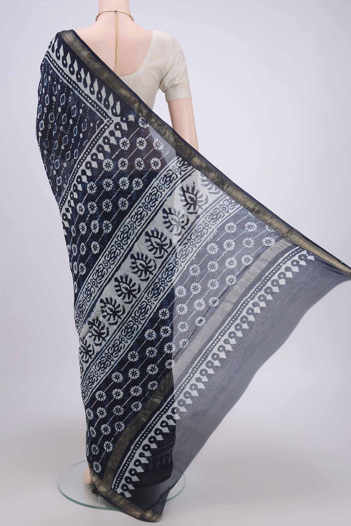 Flat view of Indigo Maheshwari Silk Cotton Saree with Batik Print on the body and Zari Border. 