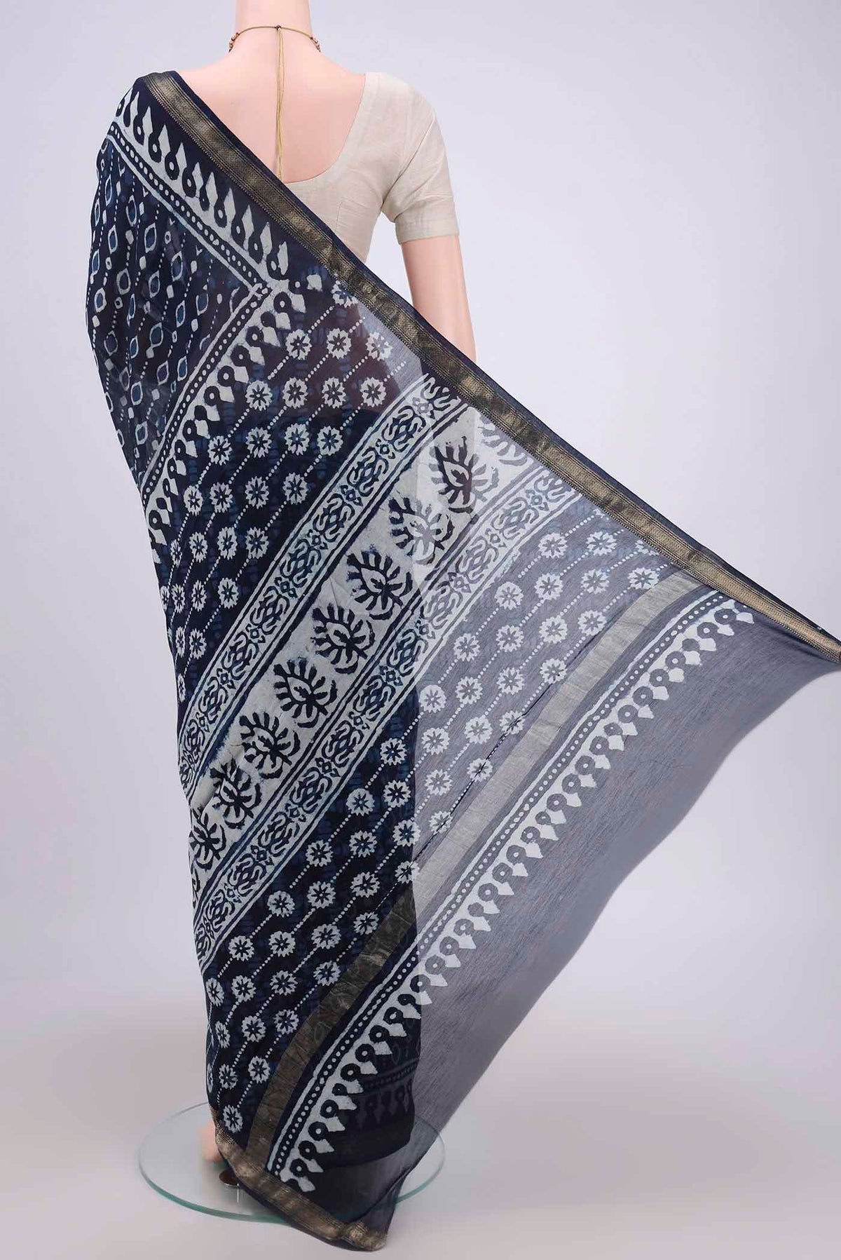 Flat view of Indigo Maheshwari Silk Cotton Saree with Batik Print on the body and Zari Border. 