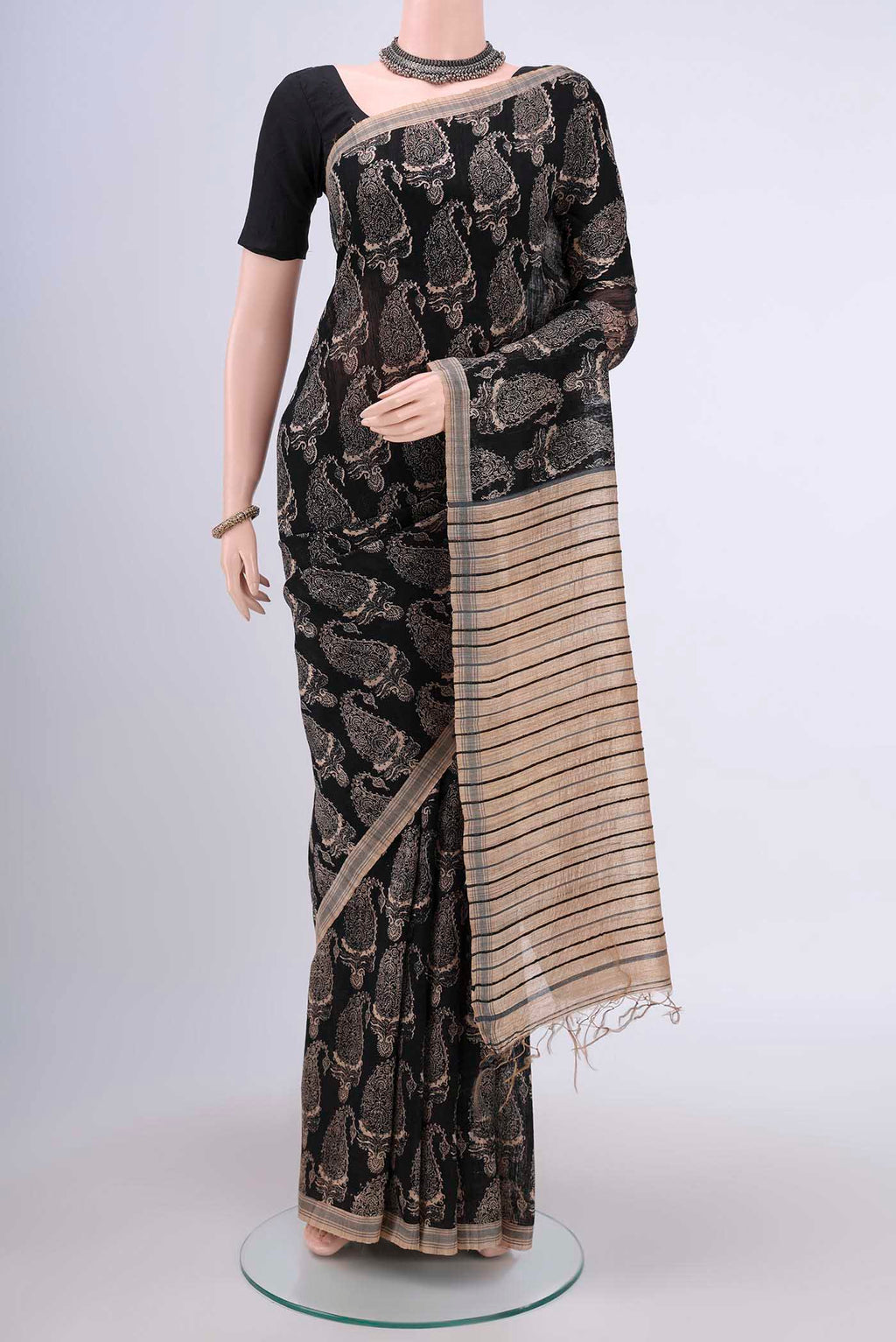 Black Tussar Silk Saree with Printed design on the body and Plain Border.  displayed on a mannequin