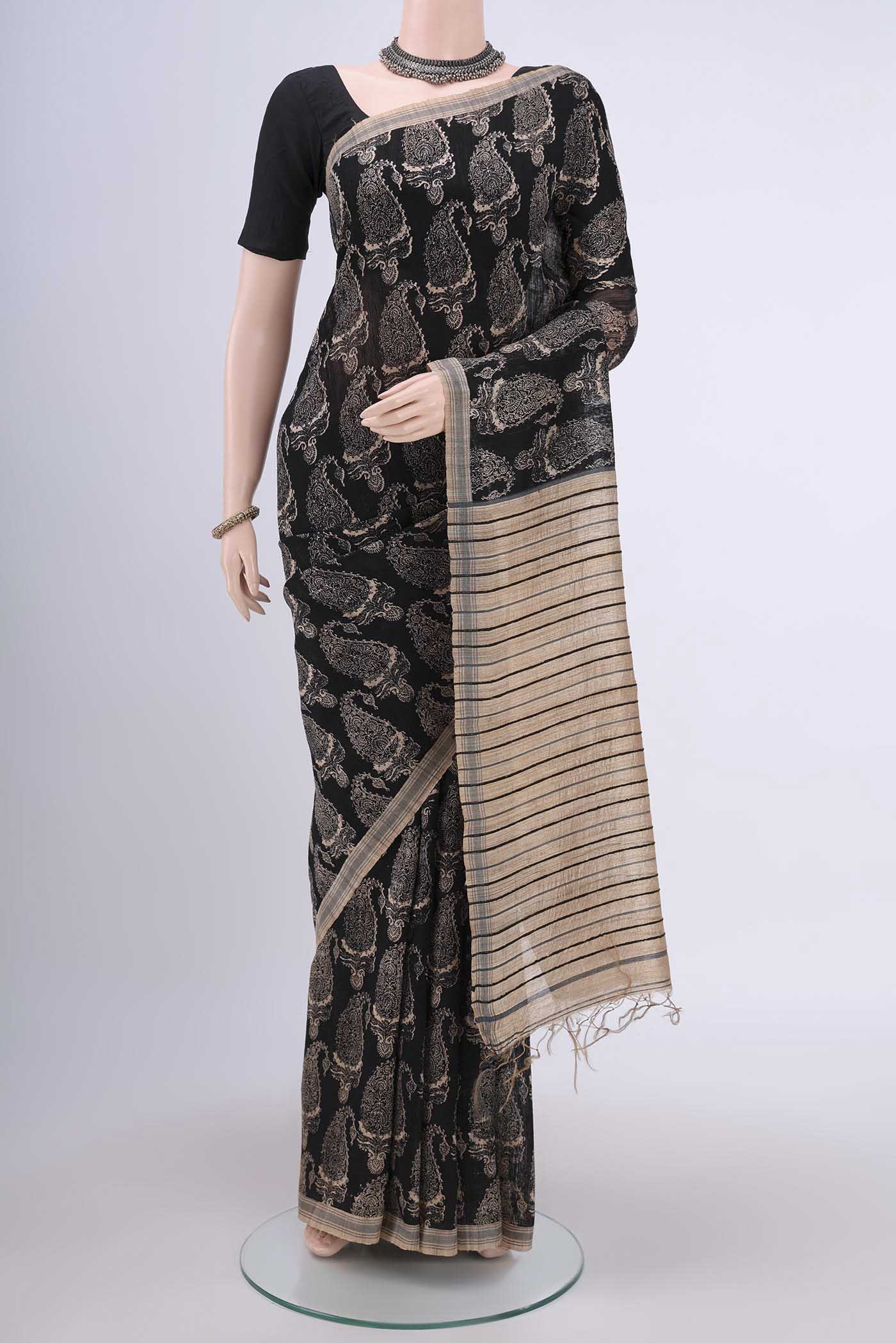 Black Tussar Silk Saree with Printed design on the body and Plain Border.  displayed on a mannequin