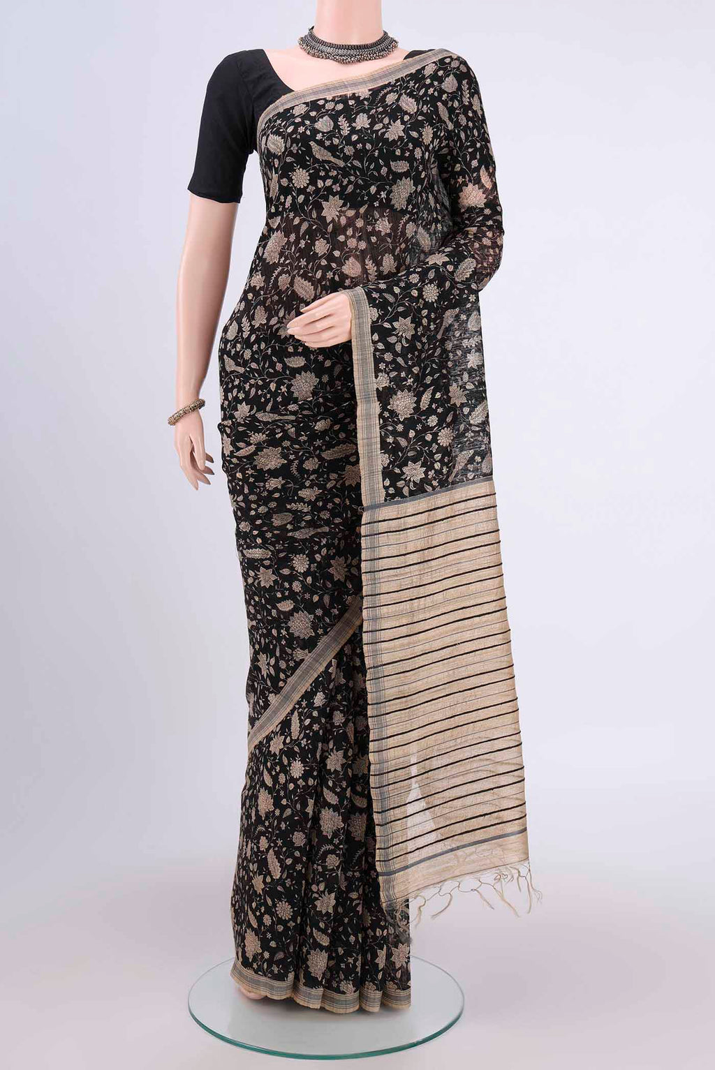 Black Tussar Silk Saree with Printed design on the body and Plain Border.  displayed on a mannequin