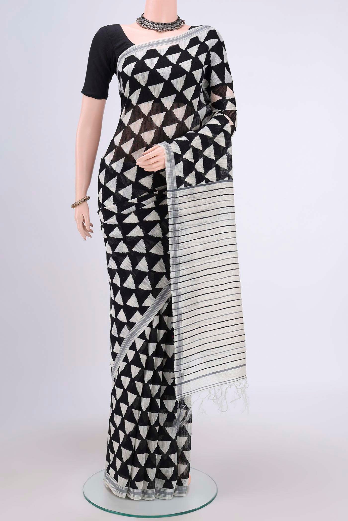Black Tussar Silk Saree with Printed design on the body and Plain Border.  displayed on a mannequin