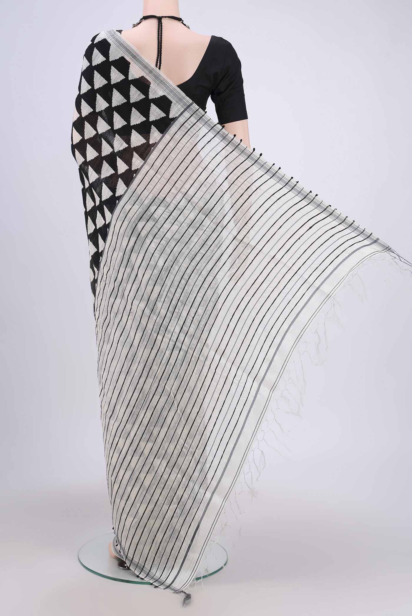 Flat view of Black Tussar Silk Saree with Printed design on the body and Plain Border. 