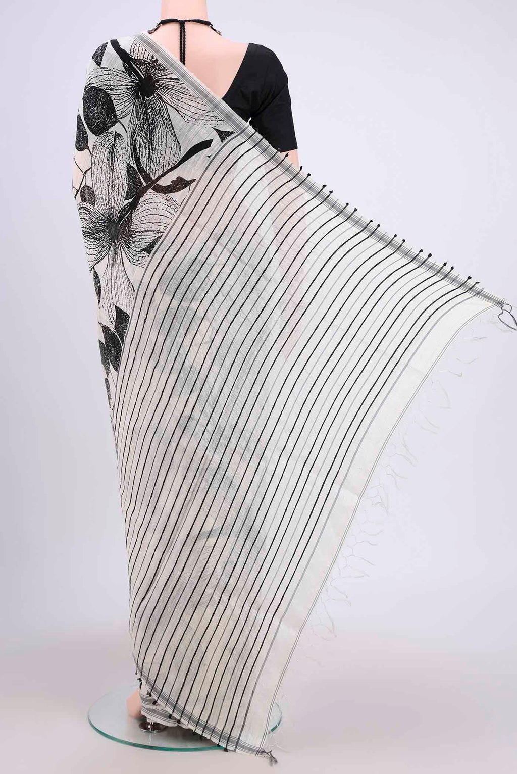 Flat view of White Tussar Silk Saree with Printed design on the body and Plain Border. 