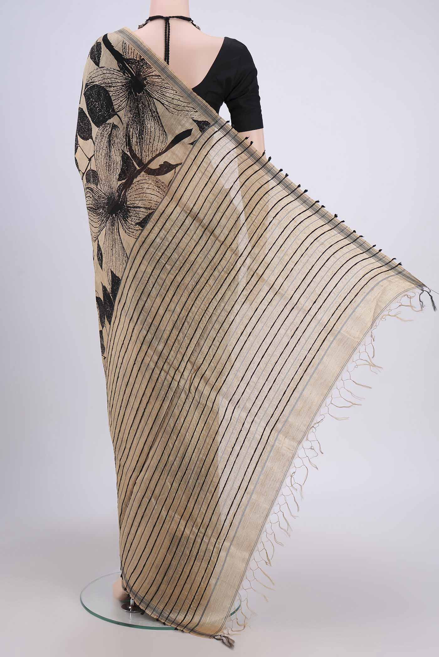 Flat view of Dark Beige Tussar Silk Saree with Printed design on the body and Plain Border. 