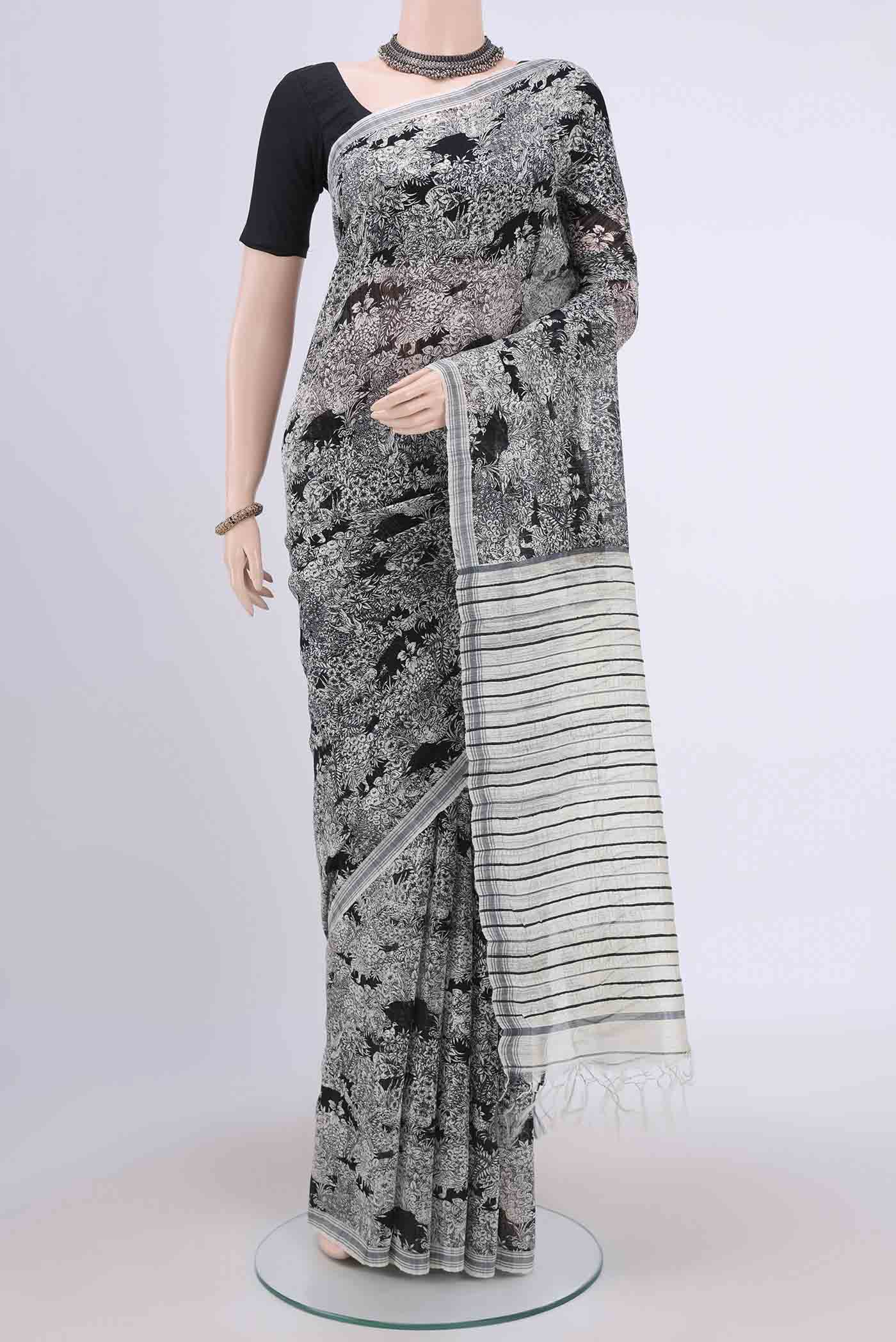 Black Tussar Silk Saree with Printed design on the body and Plain Border.  displayed on a mannequin