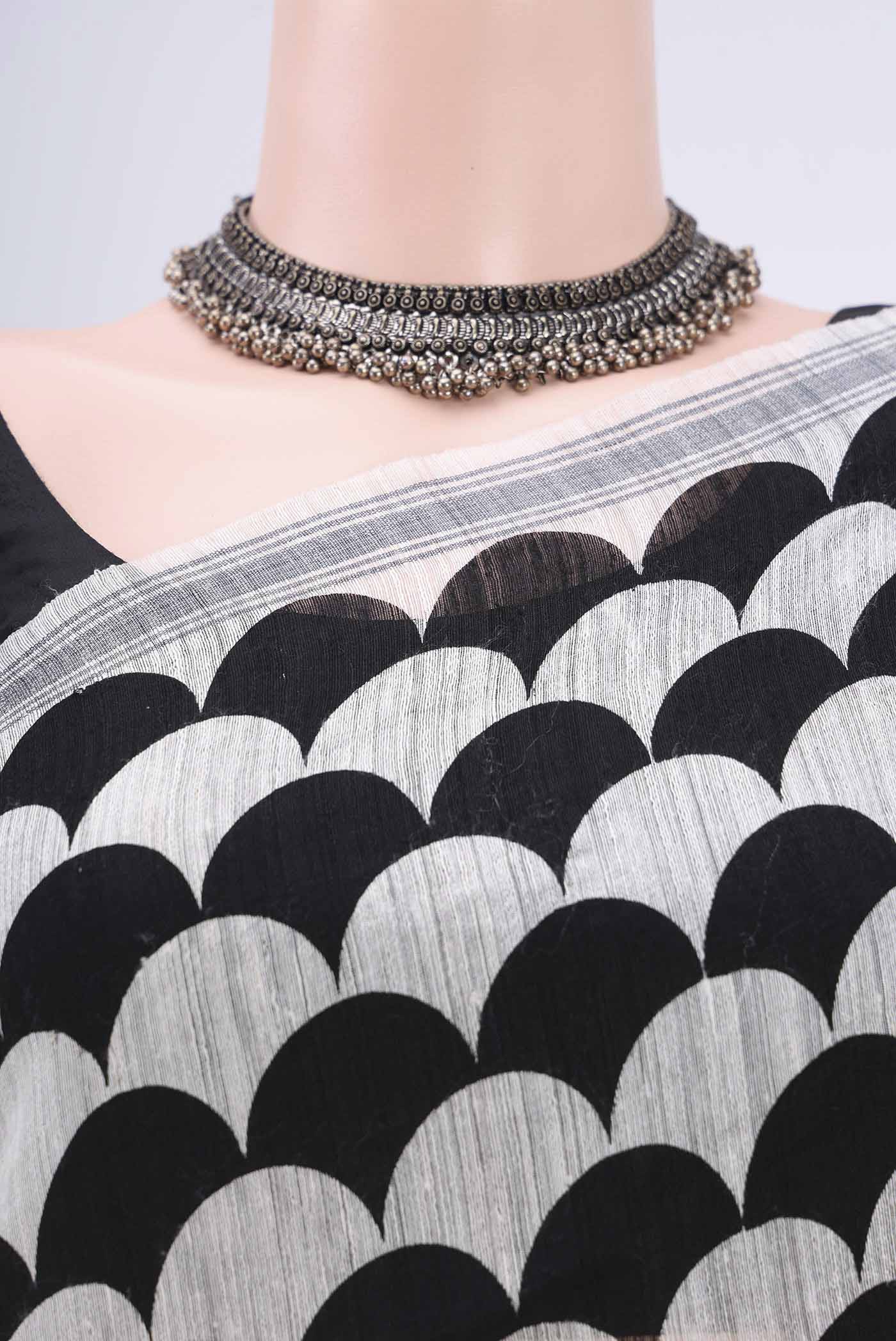 Border image of Black Tussar Silk Saree with Printed design on the body and Plain Border. 