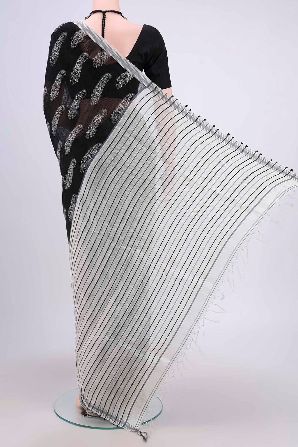 Flat view of Black Tussar Silk Saree with Printed design on the body and Plain Border. 