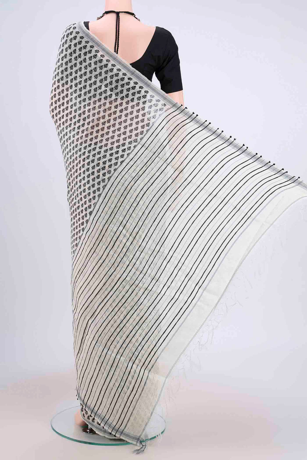 Flat view of White Tussar Silk Saree with Printed design on the body and Plain Border. 