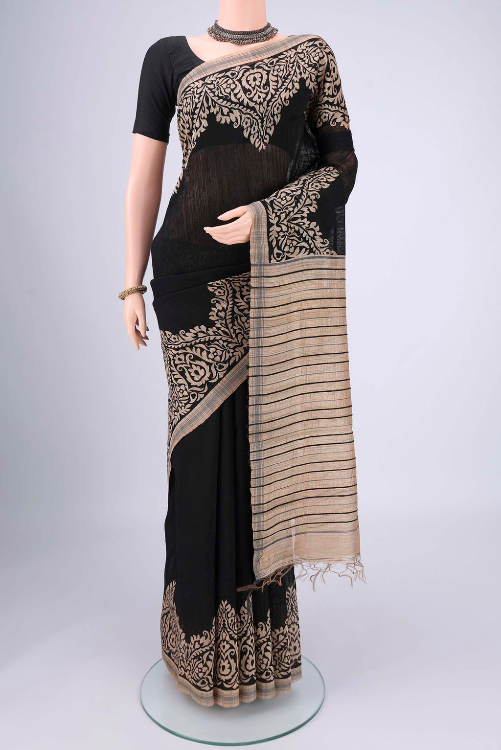 Black Tussar Silk Saree with Plain Body and Plain Border.  displayed on a mannequin