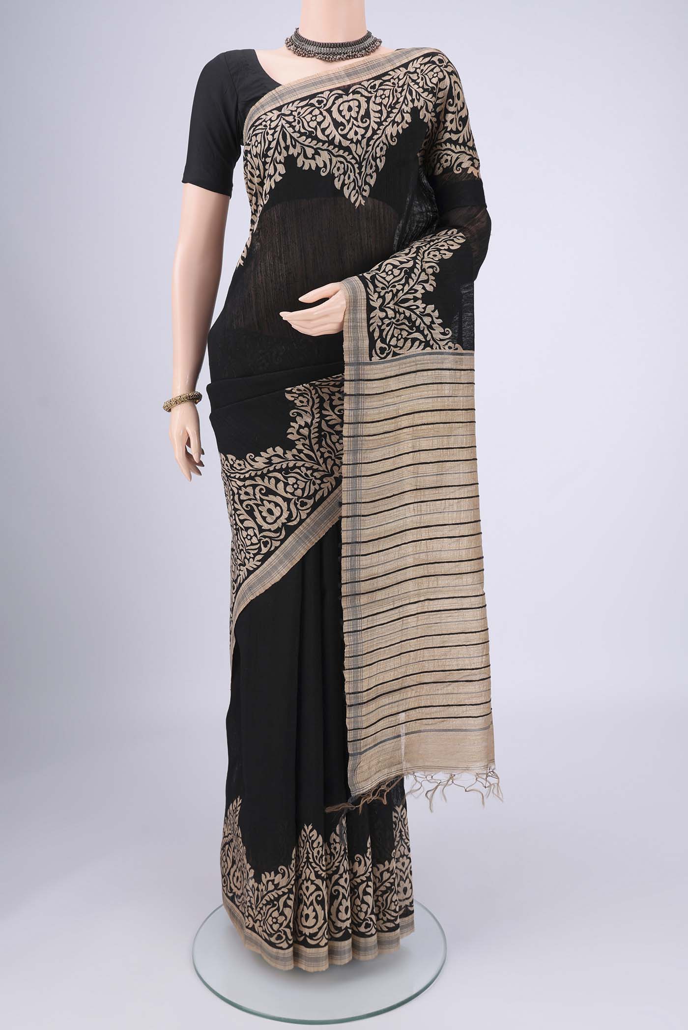 Black Tussar Silk Saree with Plain Body and Plain Border.  displayed on a mannequin