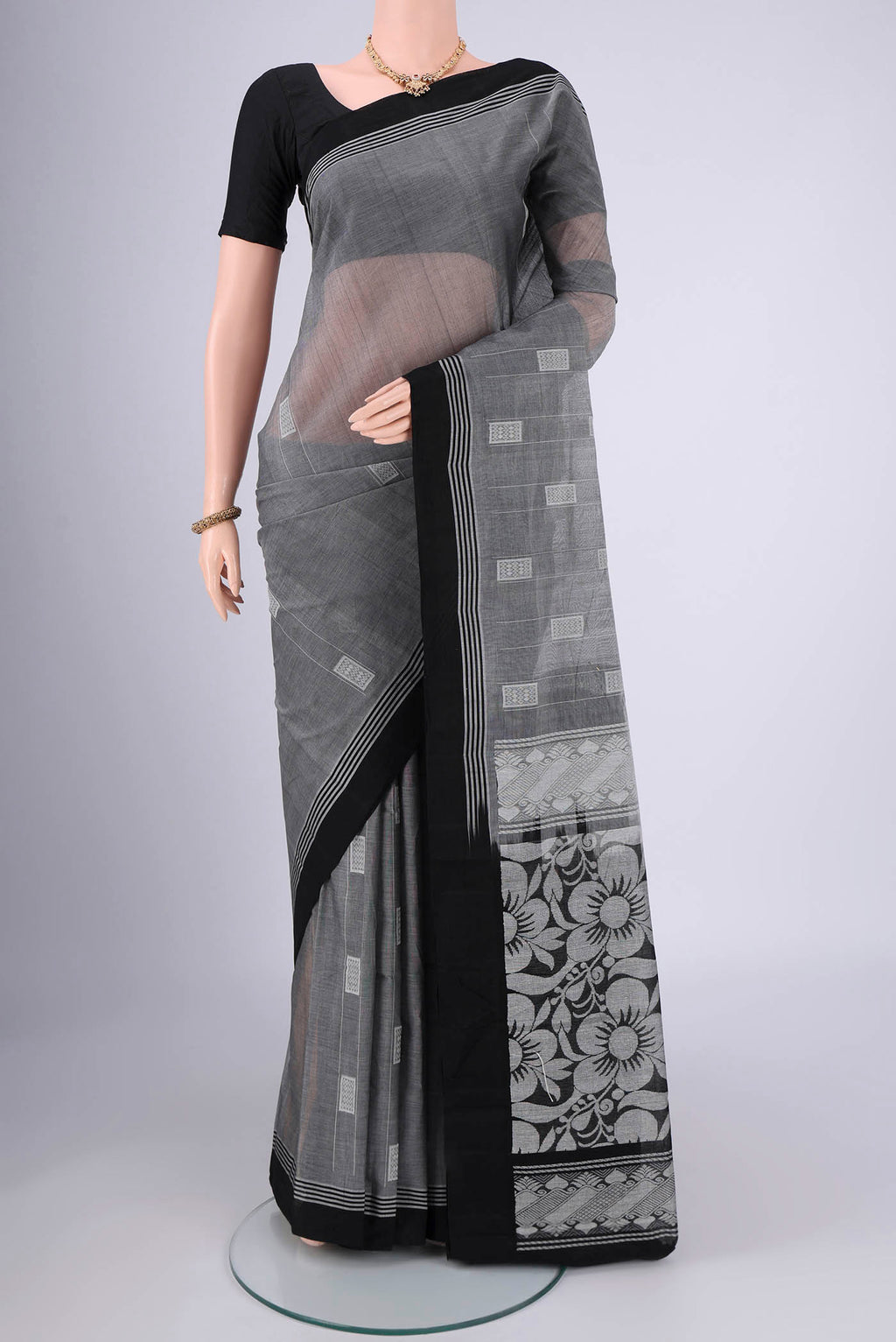 Grey Kanchi Cotton Saree with Thread Butta on the body and Plain Border.  displayed on a mannequin