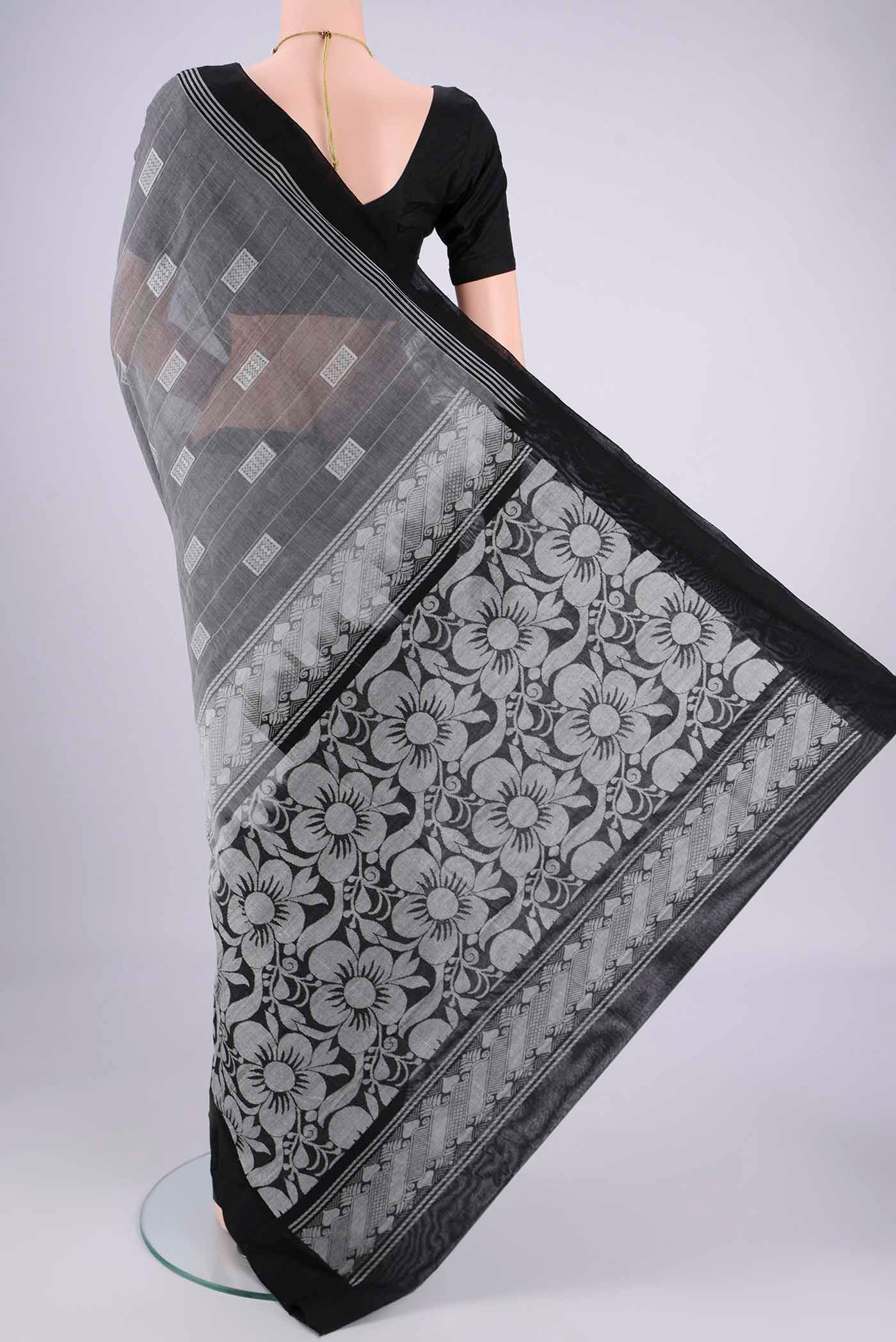 Flat view of Grey Kanchi Cotton Saree with Thread Butta on the body and Plain Border. 