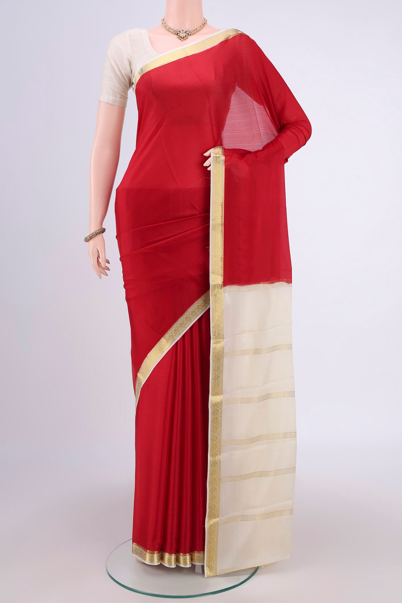 Red Mysore Crepe Saree with Plain Body and Zari Border.  displayed on a mannequin