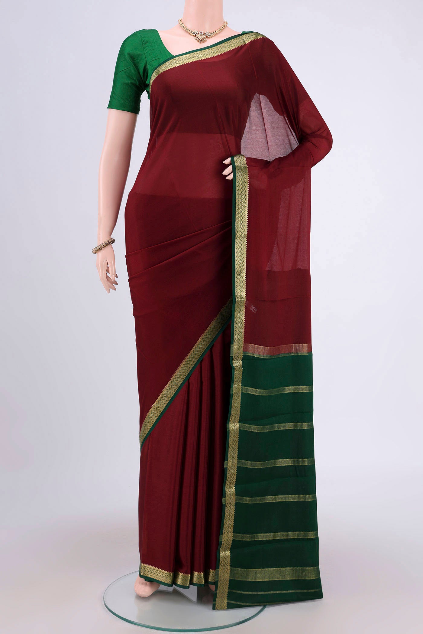Maroon Mysore Crepe Saree with Plain Body and Zari Border.  displayed on a mannequin