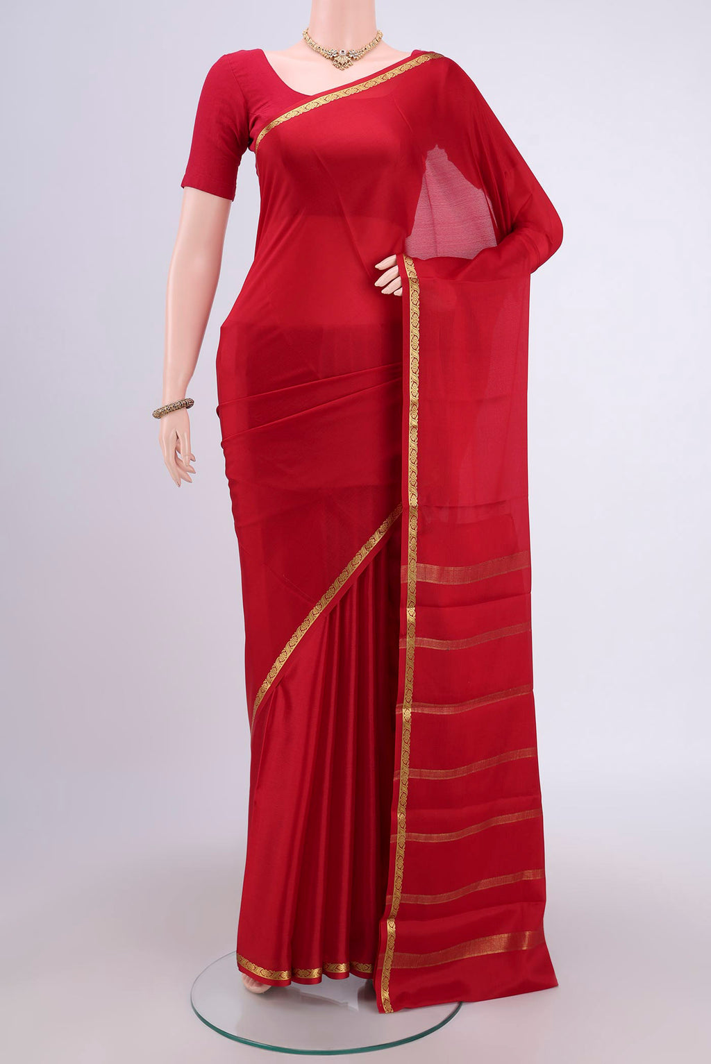 Red Mysore Crepe Saree with Plain Body and Zari Border.  displayed on a mannequin