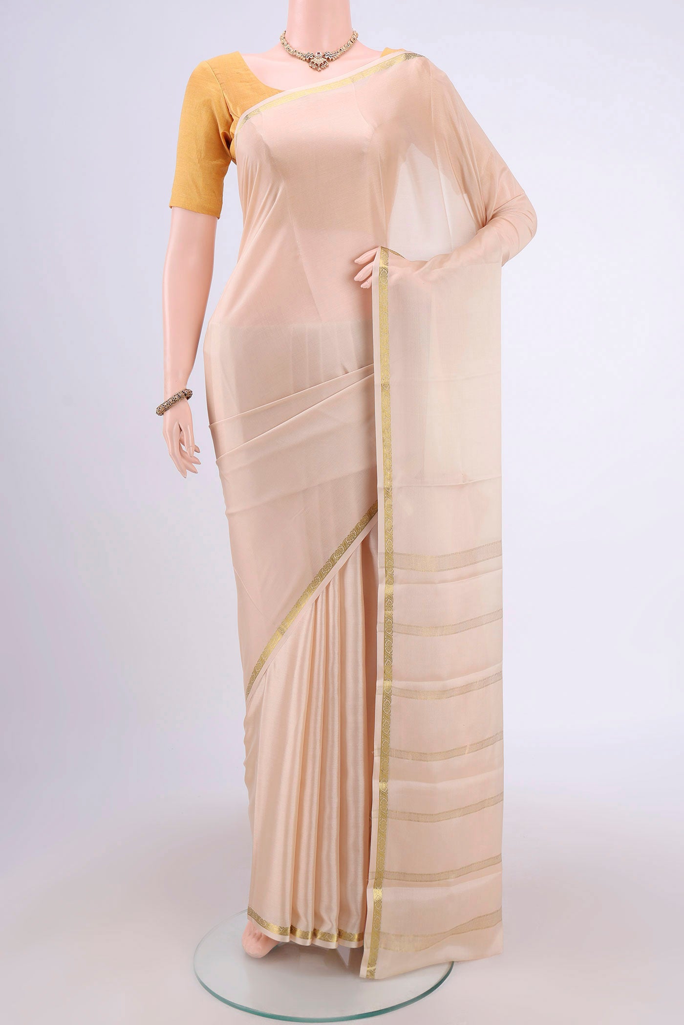 Cream Mysore Crepe Saree with Plain Body and Zari Border.  displayed on a mannequin