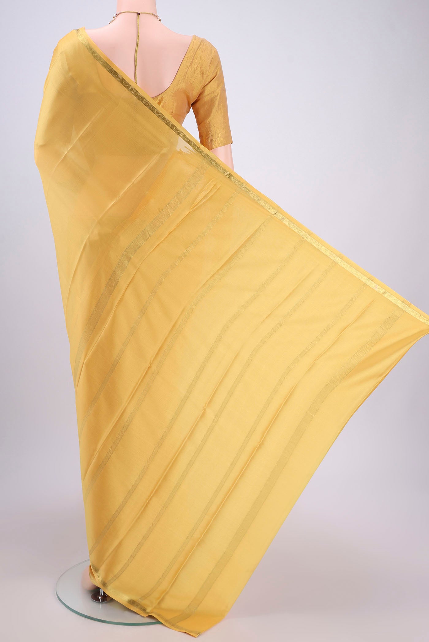 Flat view of Yellow Mysore Crepe Saree with Plain Body and Zari Border. 