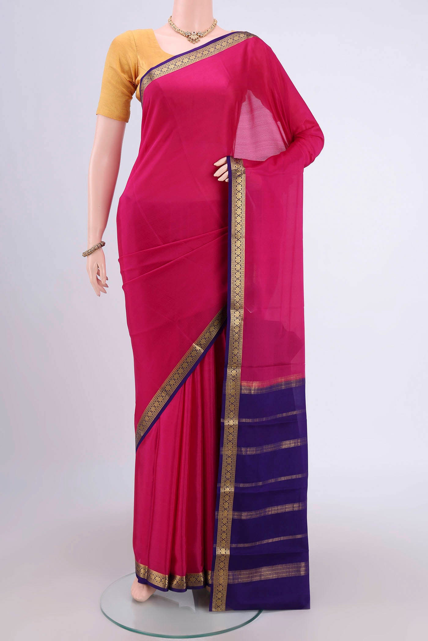 Rani Pink Mysore Crepe Saree with Plain Body and Zari Border.  displayed on a mannequin