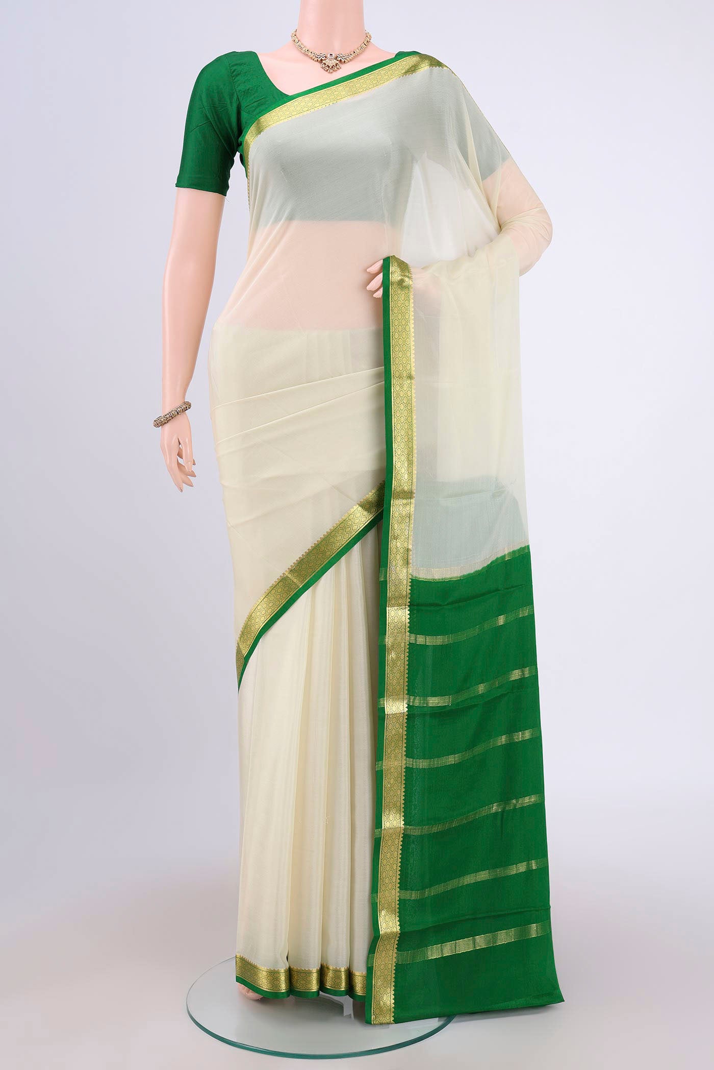 Off White Mysore Crepe Saree with Plain Body and Zari Border.  displayed on a mannequin