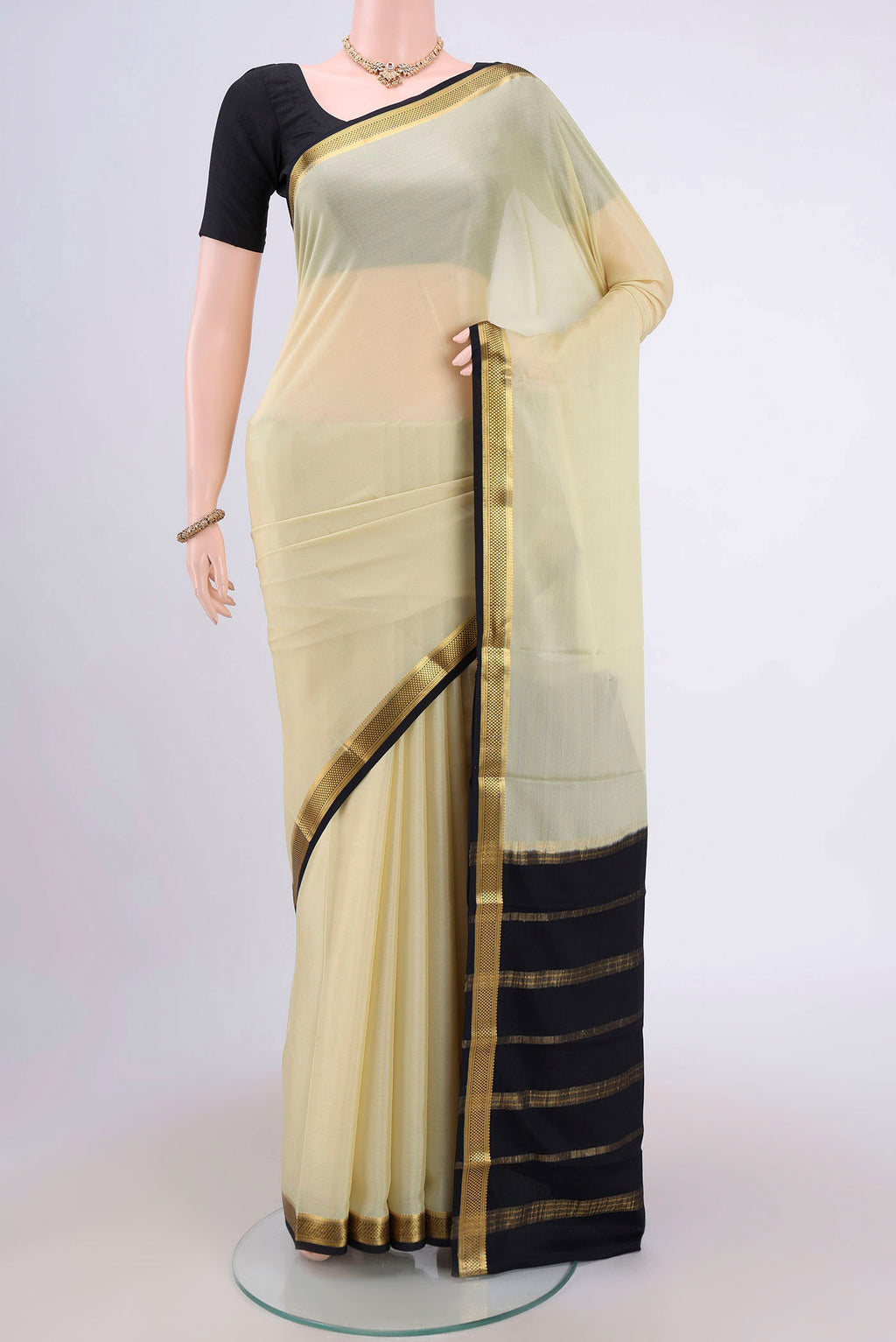 Cream Mysore Crepe Saree with Plain Body and Zari Border.  displayed on a mannequin