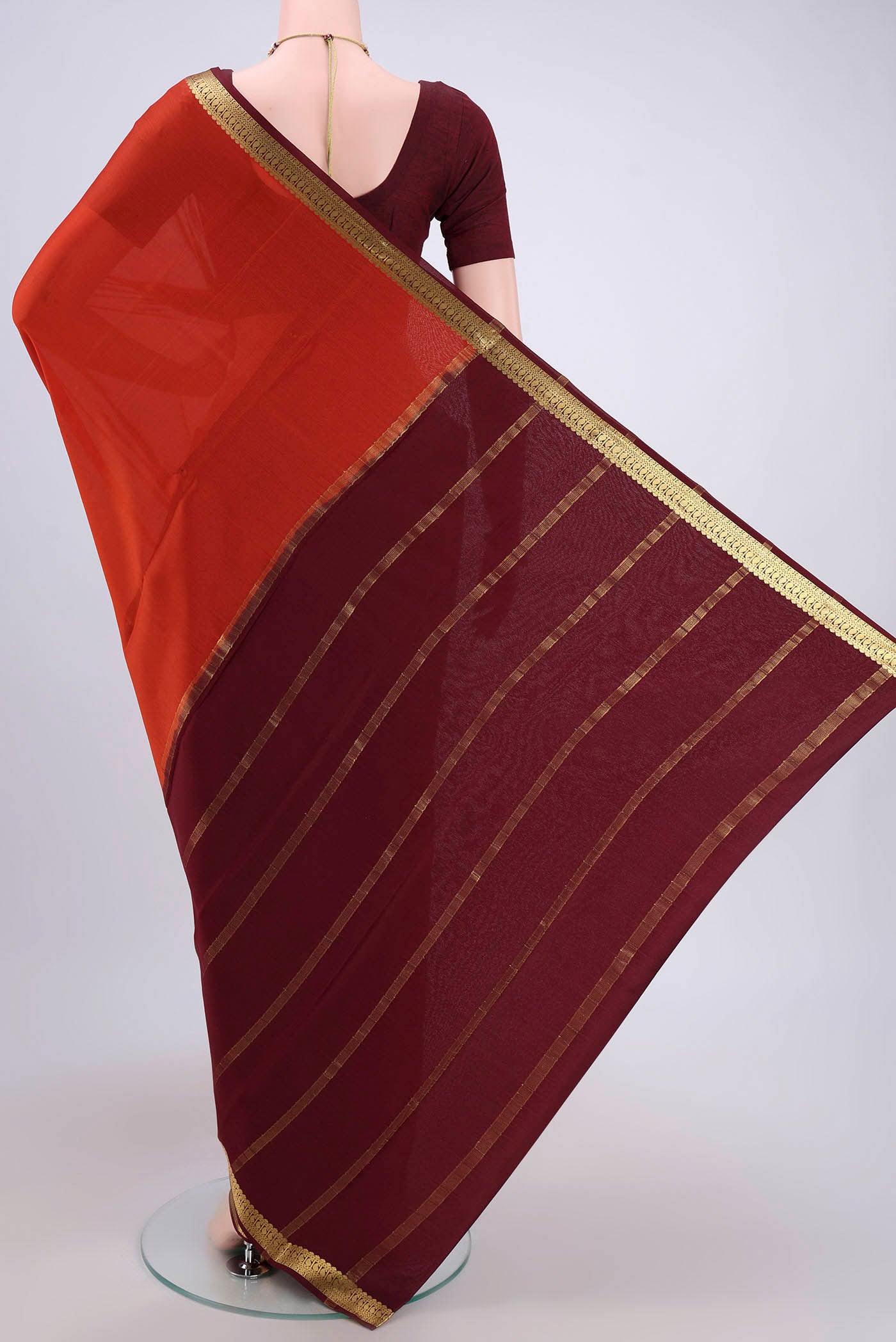 Flat view of Rust Mysore Crepe Saree with Plain Body and Zari Border. 