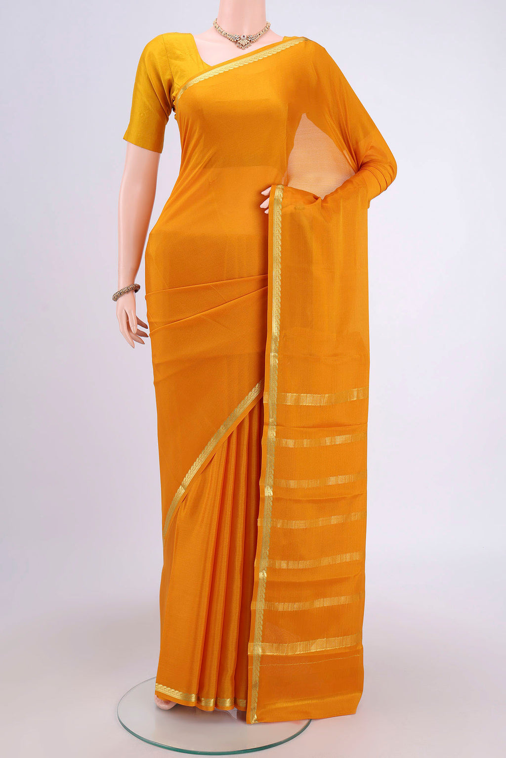 Mustard Mysore Crepe Saree with Plain Body and Zari Border.  displayed on a mannequin