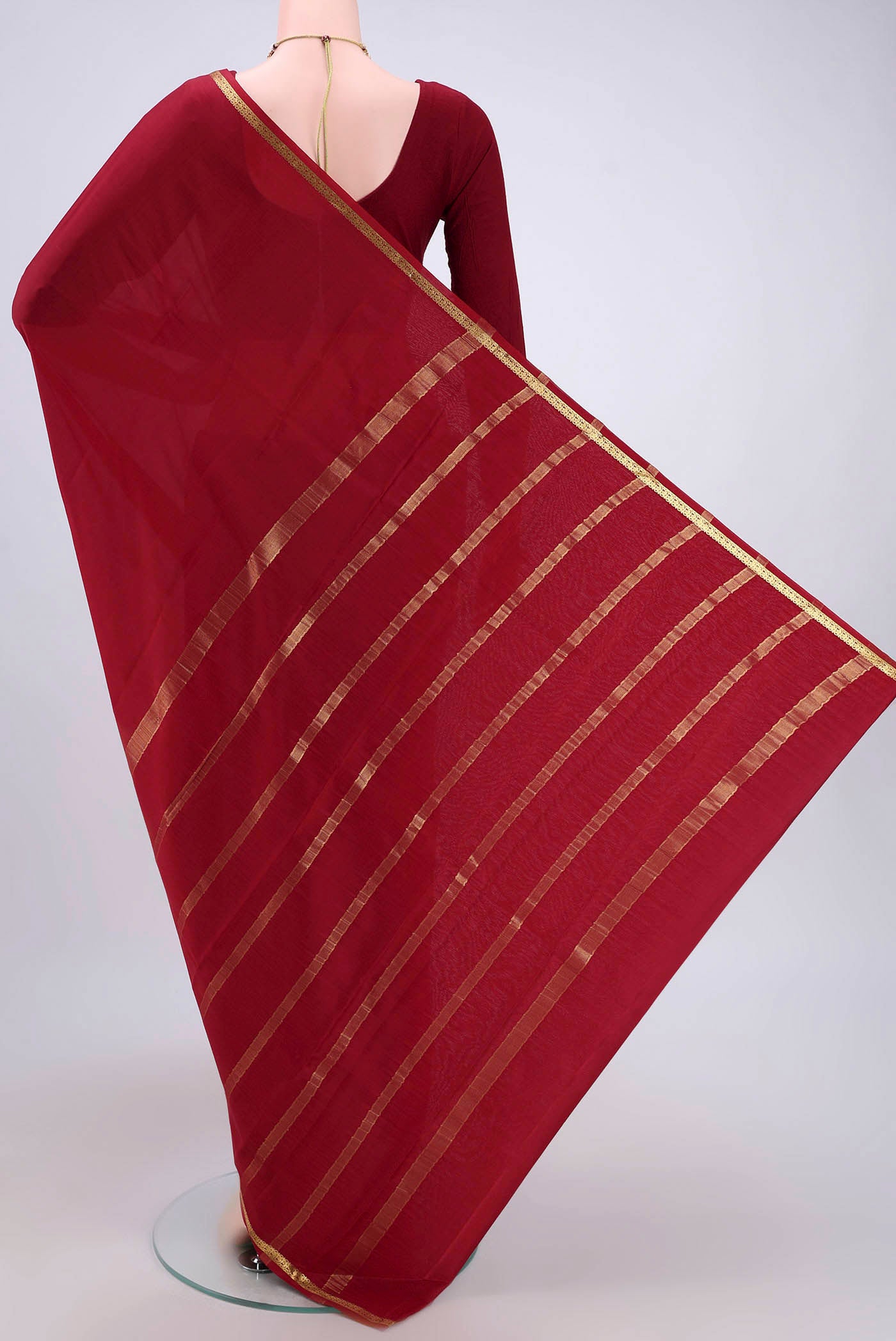 Flat view of Maroon Mysore Crepe Saree with Plain Body and Zari Border. 