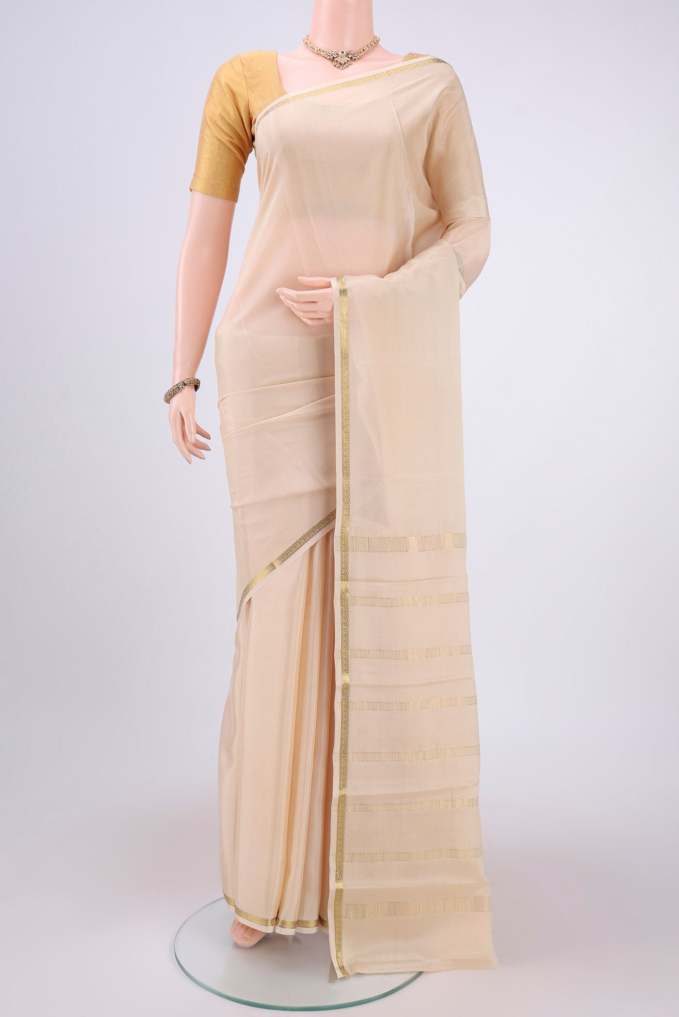 Cream Mysore Crepe Saree with Plain Body and Zari Border.  displayed on a mannequin