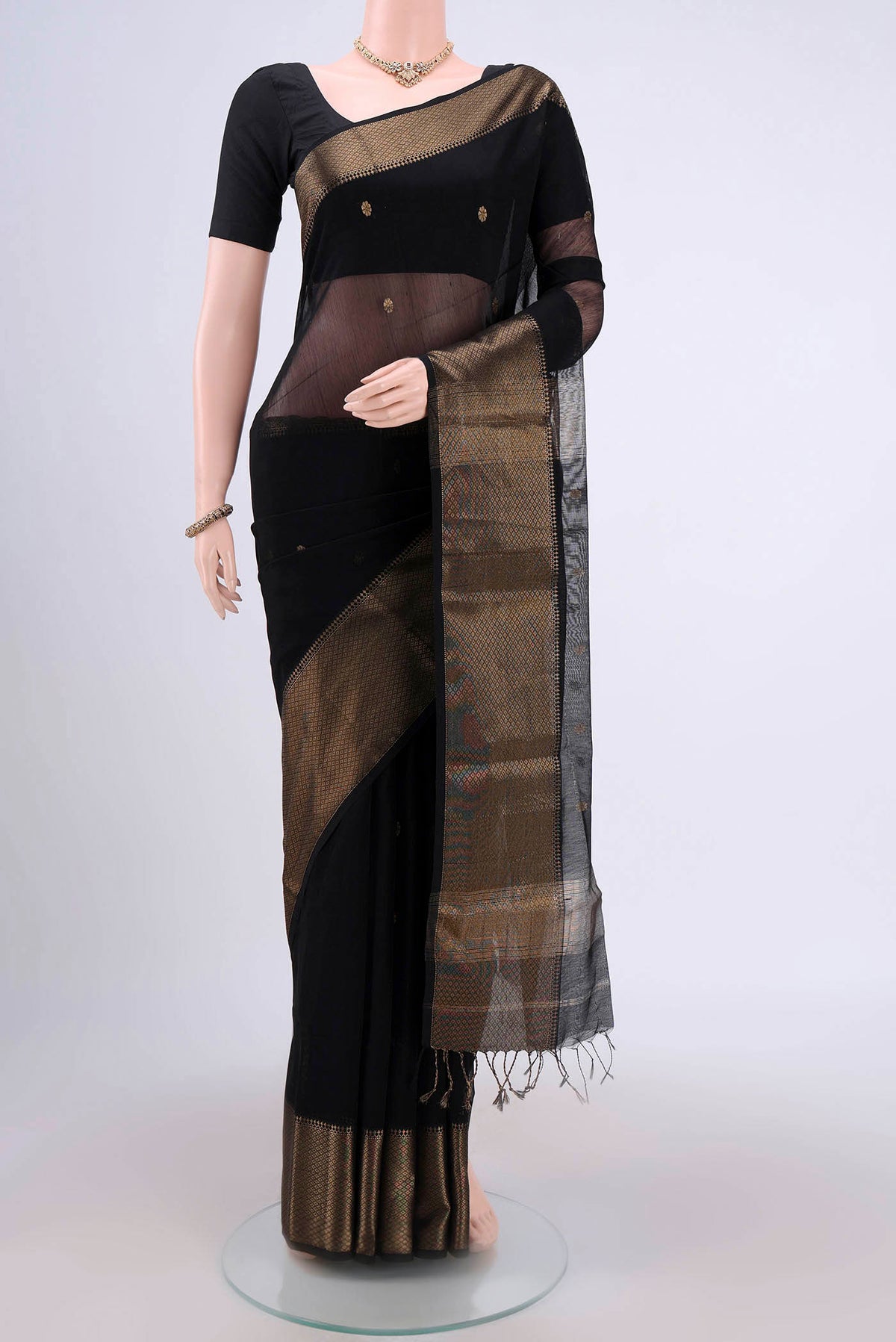 Black Maheshwari Silk Cotton Saree with Stripes on the body and Zari Border.  displayed on a mannequin