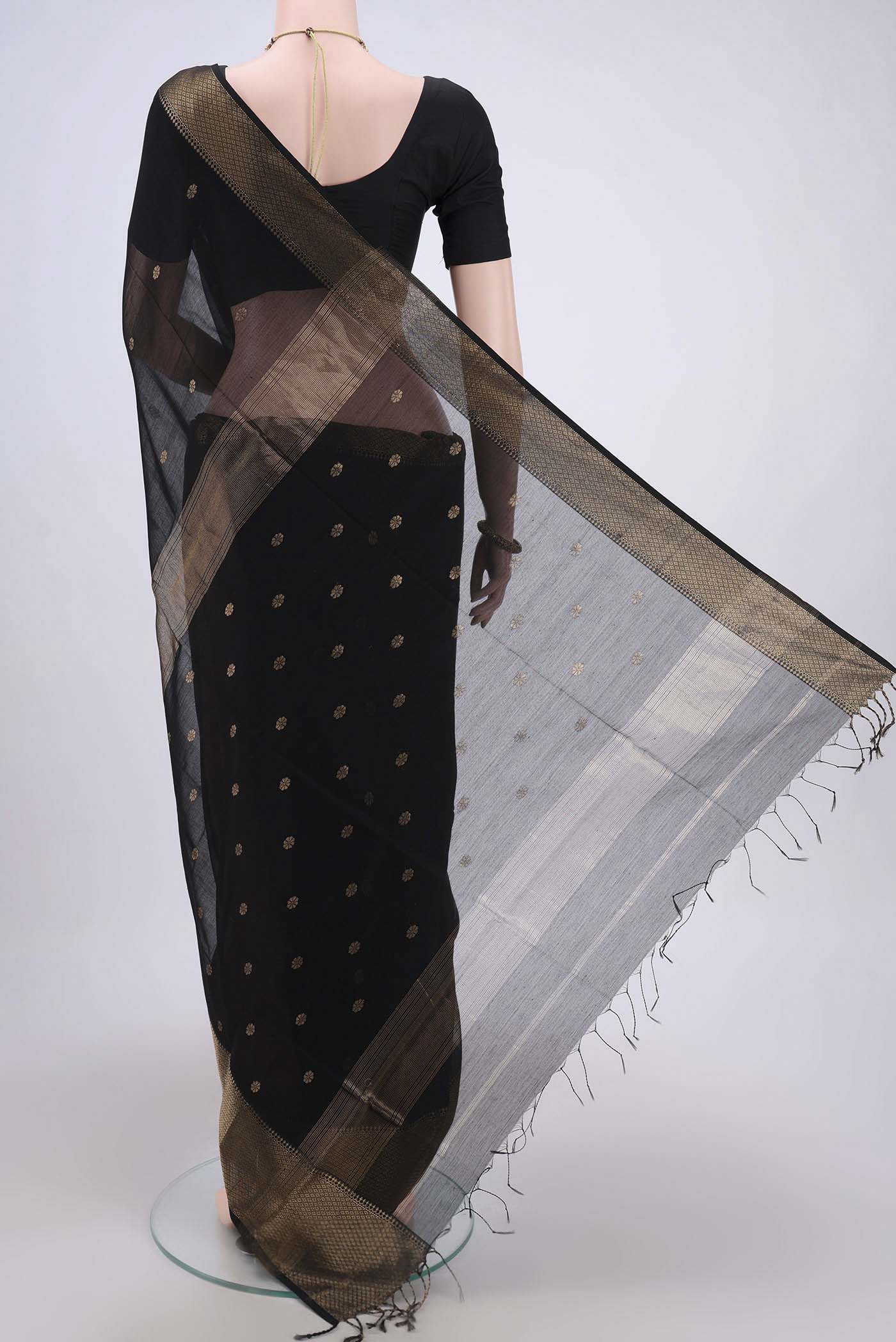 Flat view of Black Maheshwari Silk Cotton Saree with Stripes on the body and Zari Border. 