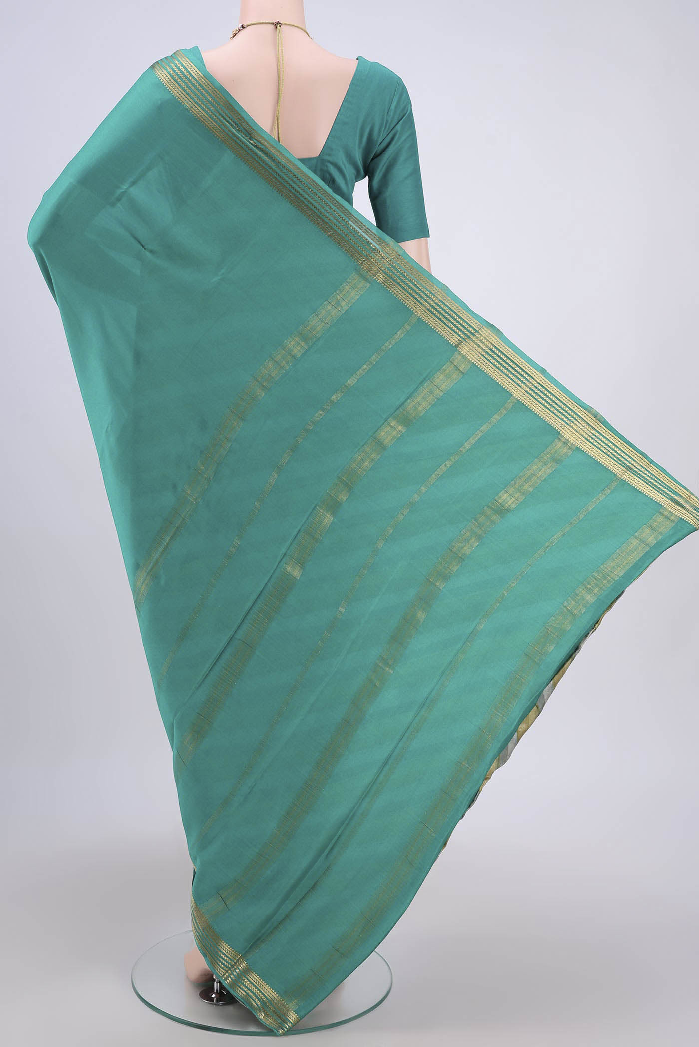 Flat view of Sea Green Mysore Crepe Saree with Plain Body and Zari Border. 