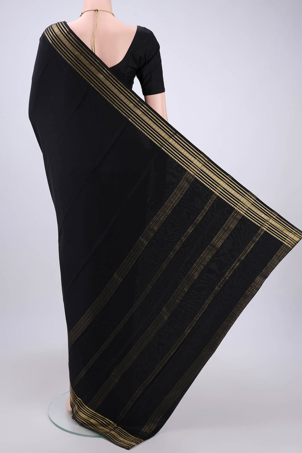 Flat view of Black Mysore Crepe Saree with Plain Body and Zari Border. 