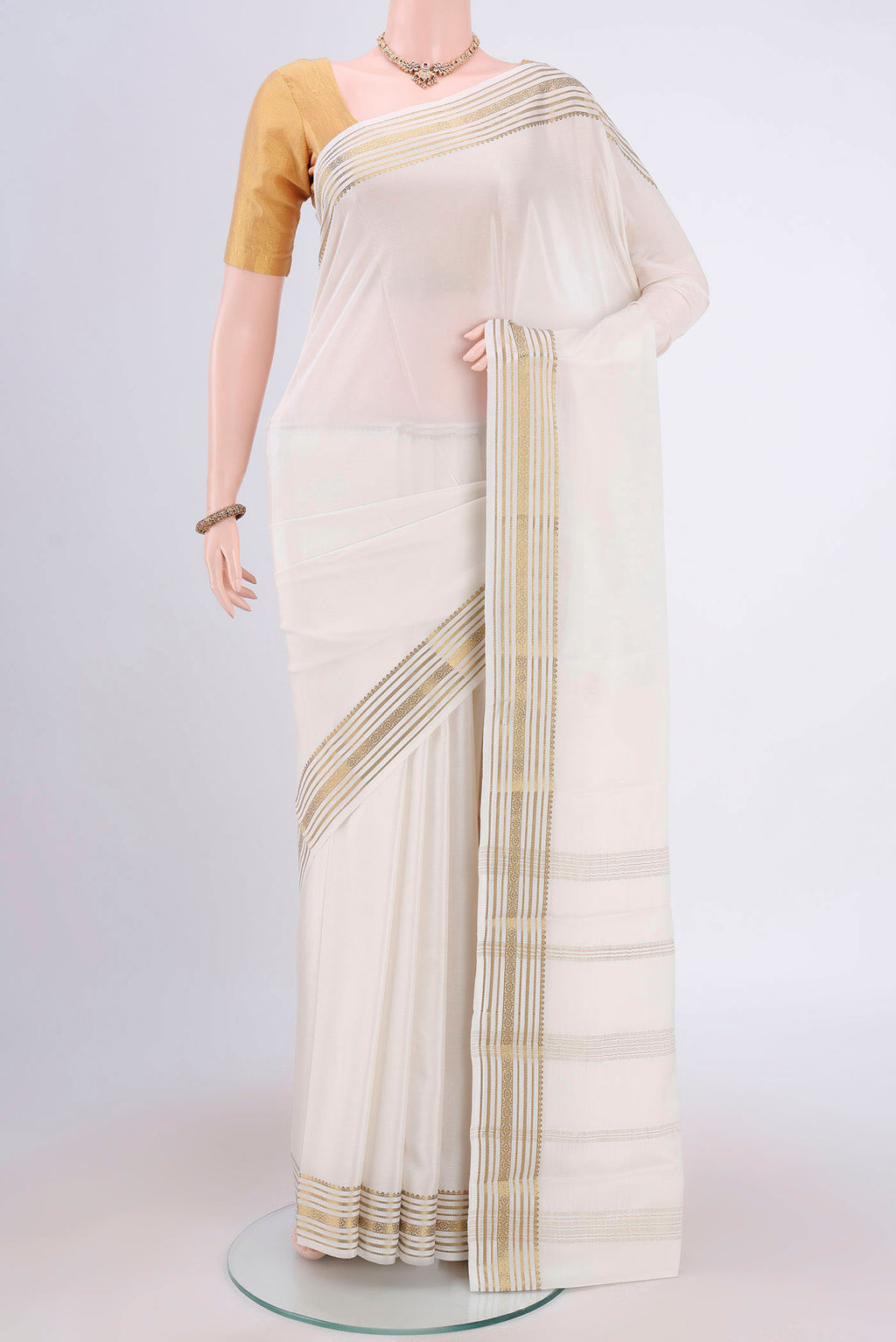 Off White Mysore Crepe Saree with Plain Body and Zari Border.  displayed on a mannequin