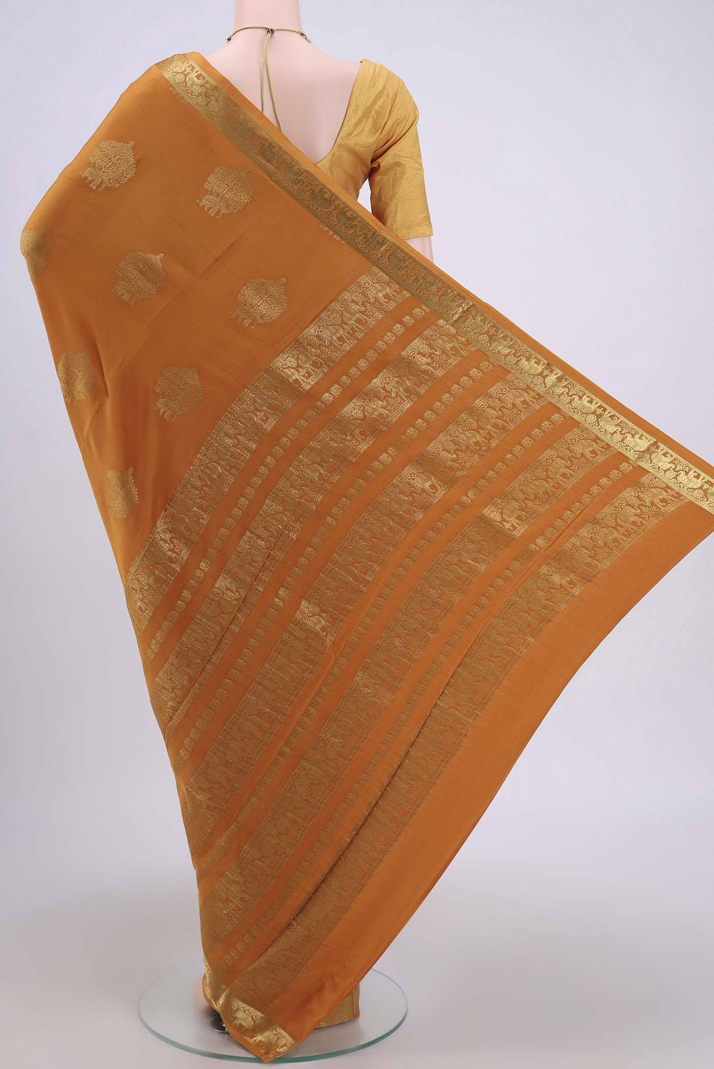 Flat view of Mustard Mysore Crepe Saree with Zari Butta on the body and Zari Border. 