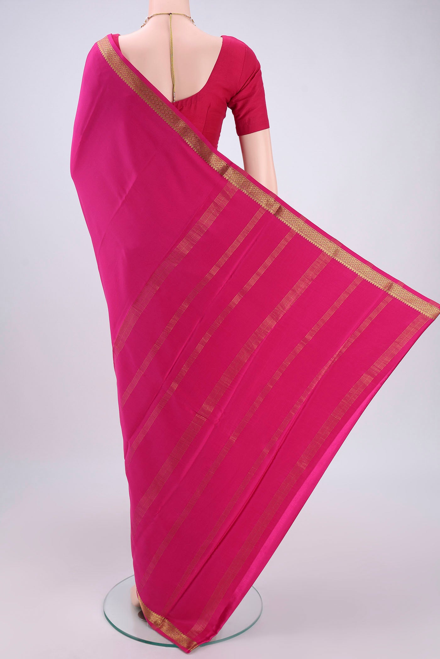 Flat view of Rani Pink Mysore Crepe Saree with Plain Body and Zari Border. 