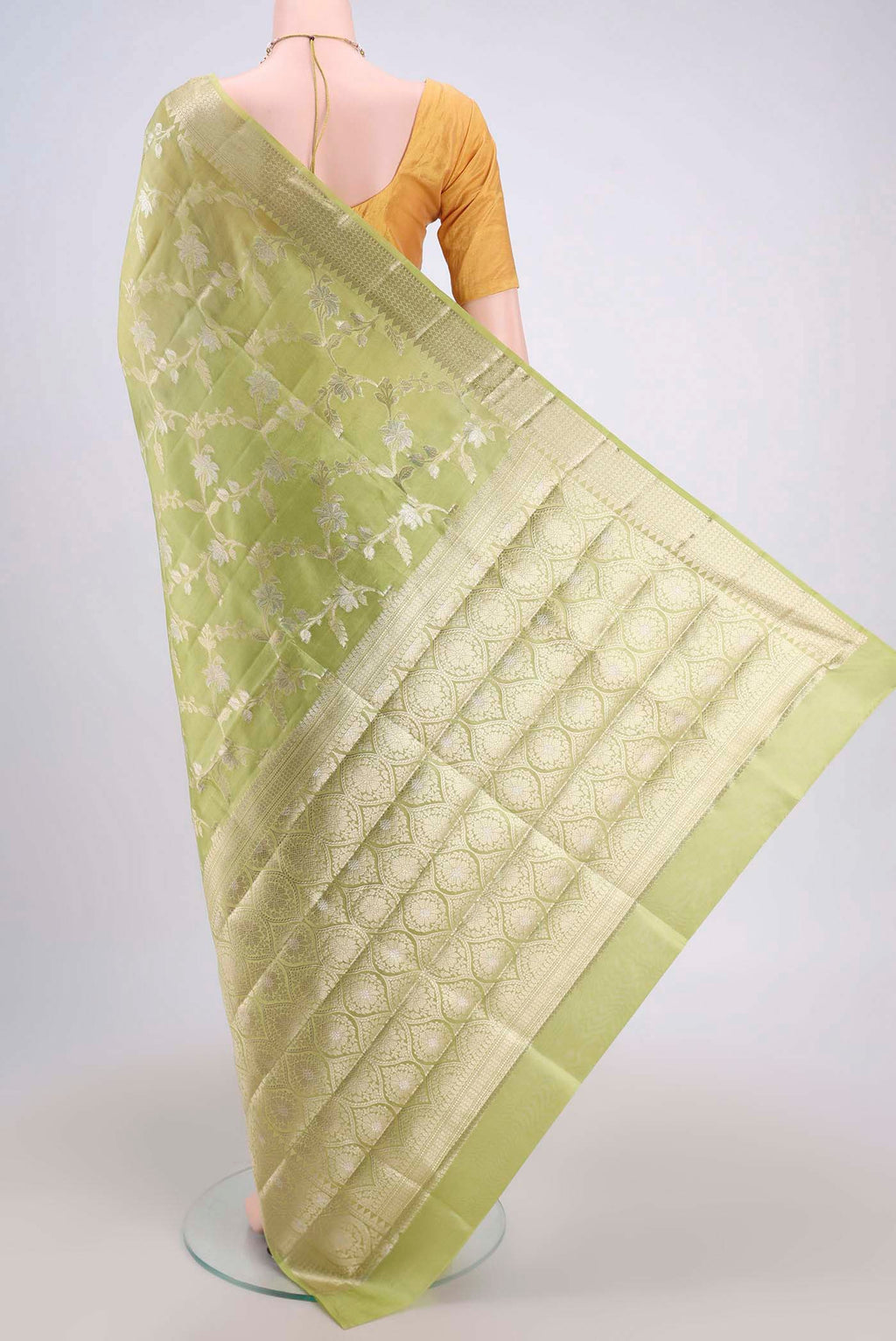 Flat view of Light Green Banarasi Raw Silk Saree with Zari Butta on the body and Zari Border. 