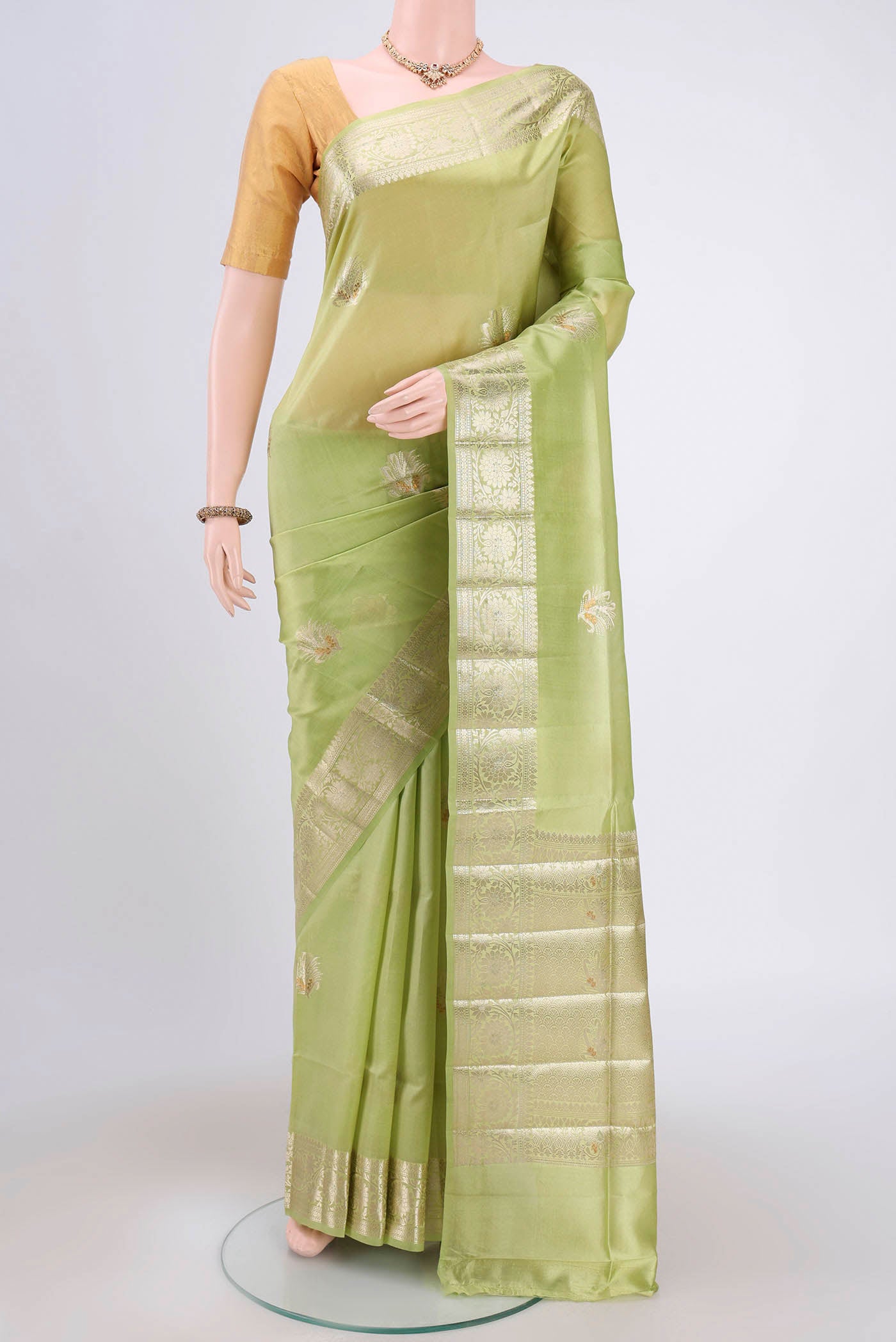 Acid Green Banarasi Raw Silk Saree with Zari Butta on the body and Zari Border.  displayed on a mannequin