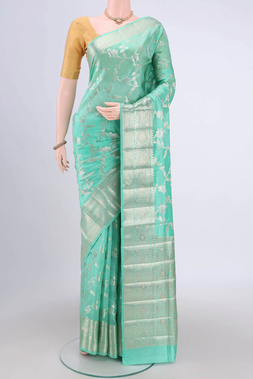 Mint Green Banarasi Raw Silk Saree with Zari Brocade on the body and Zari Border.  displayed on a mannequin