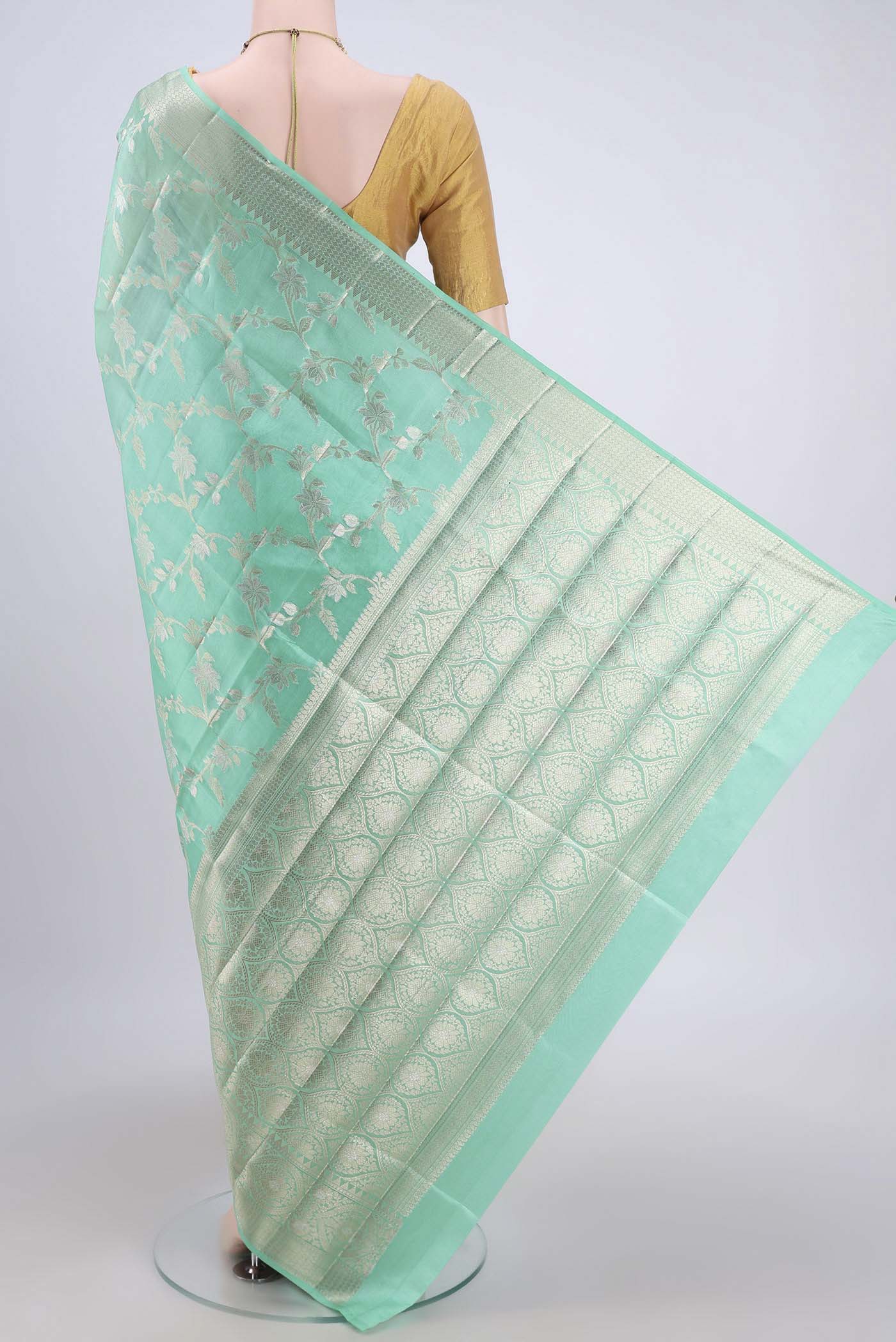 Flat view of Mint Green Banarasi Raw Silk Saree with Zari Brocade on the body and Zari Border. 